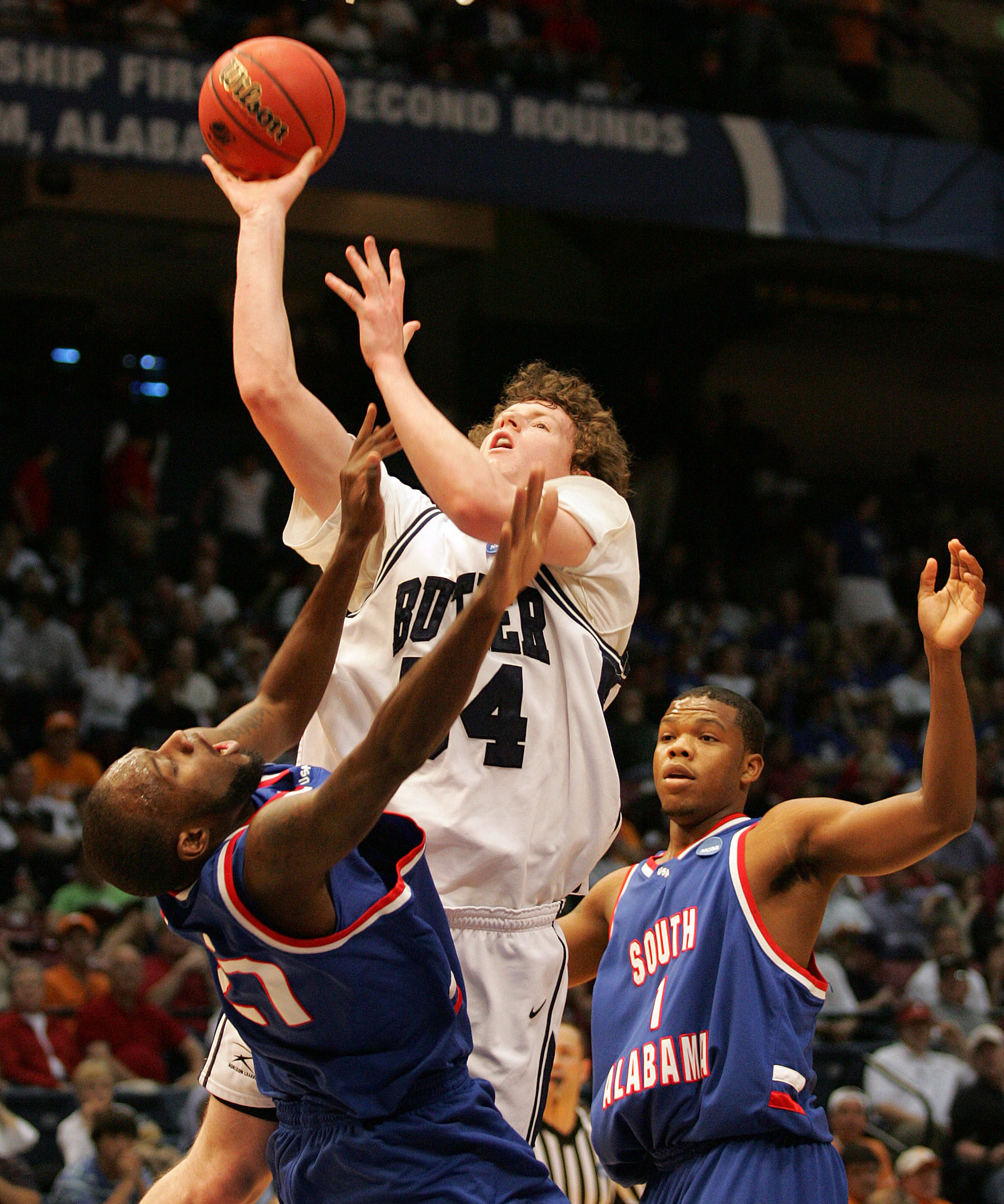 BIRMINGHAM, AL - MARCH 21: Matt Howard #54 of the Butler Bulldogs shoots over Brandon Davis #21 and DeAndre Coleman #1 of the South Alabama Jaguars during the first round of the South Regional as part of the 2008 NCAA Men's Basketball Tournament at the B
