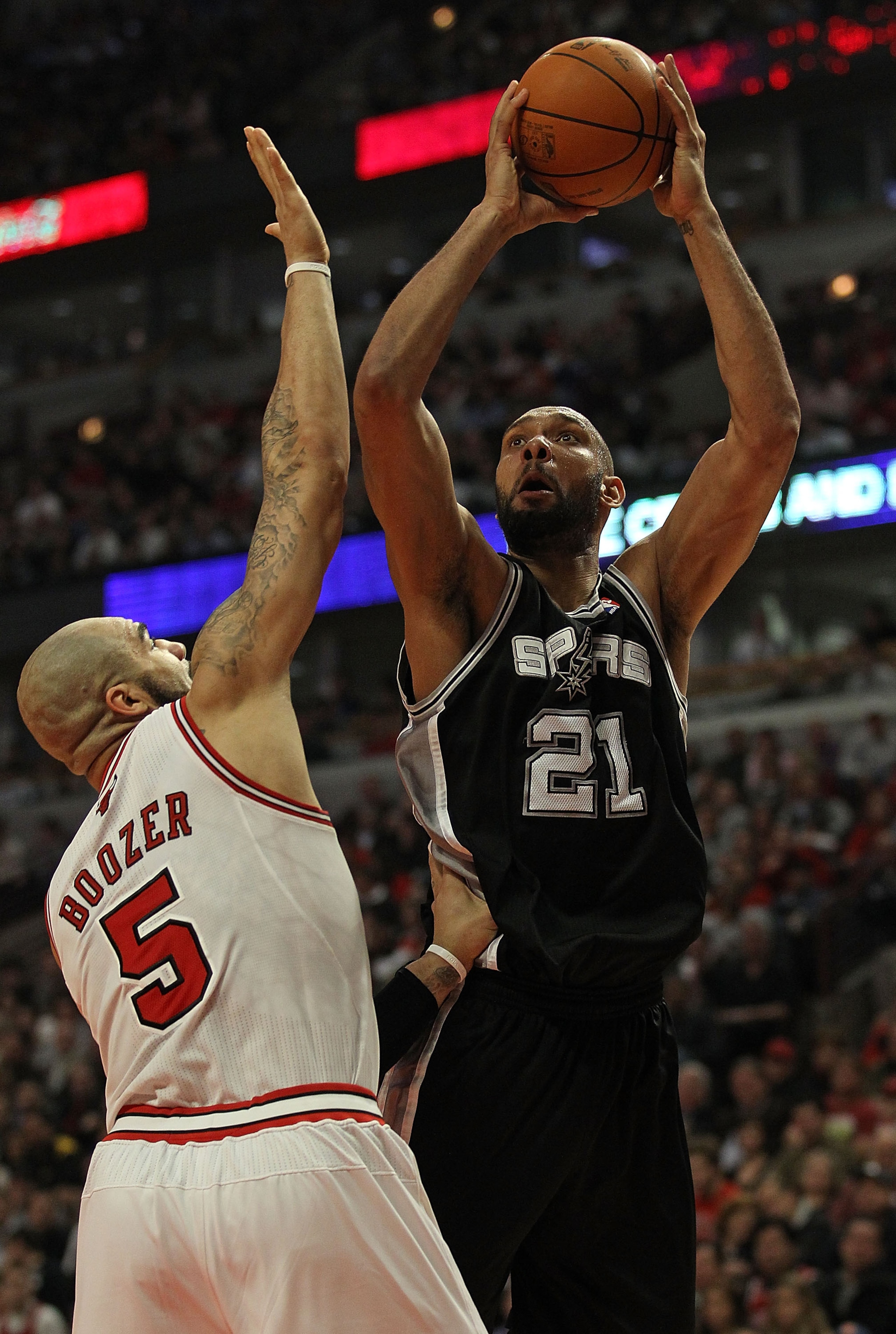CHICAGO, IL - FEBRUARY 17: Tim Duncan #21 of the San Antonio Spurs puts up a shot over Carlos Boozer #5 of the Chicago Bulls at the United Center on February 17, 2011 in Chicago, Illinois. The Bulls defeated the Spurs 109-99. NOTE TO USER: User expressly