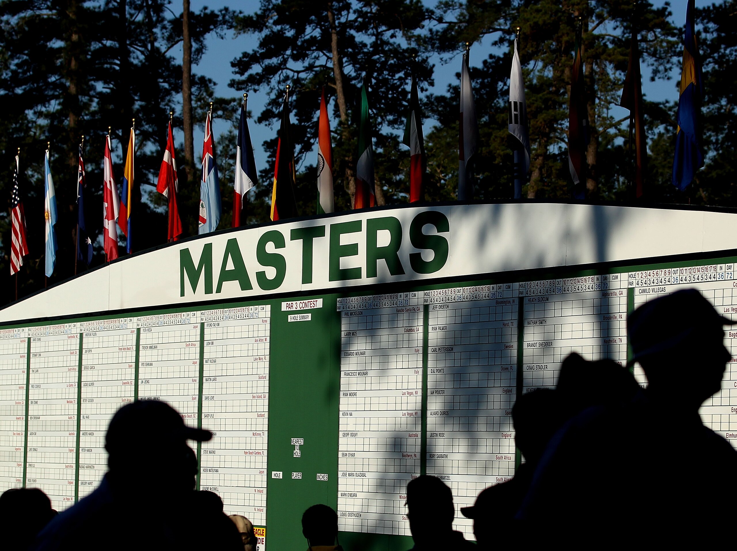 AUGUSTA, GA - APRIL 04:  Patrons pass before a Masters leaderboard during a practice round prior to the 2011 Masters Tournament at Augusta National Golf Club on April 4, 2011 in Augusta, Georgia.  (Photo by Andrew Redington/Getty Images)