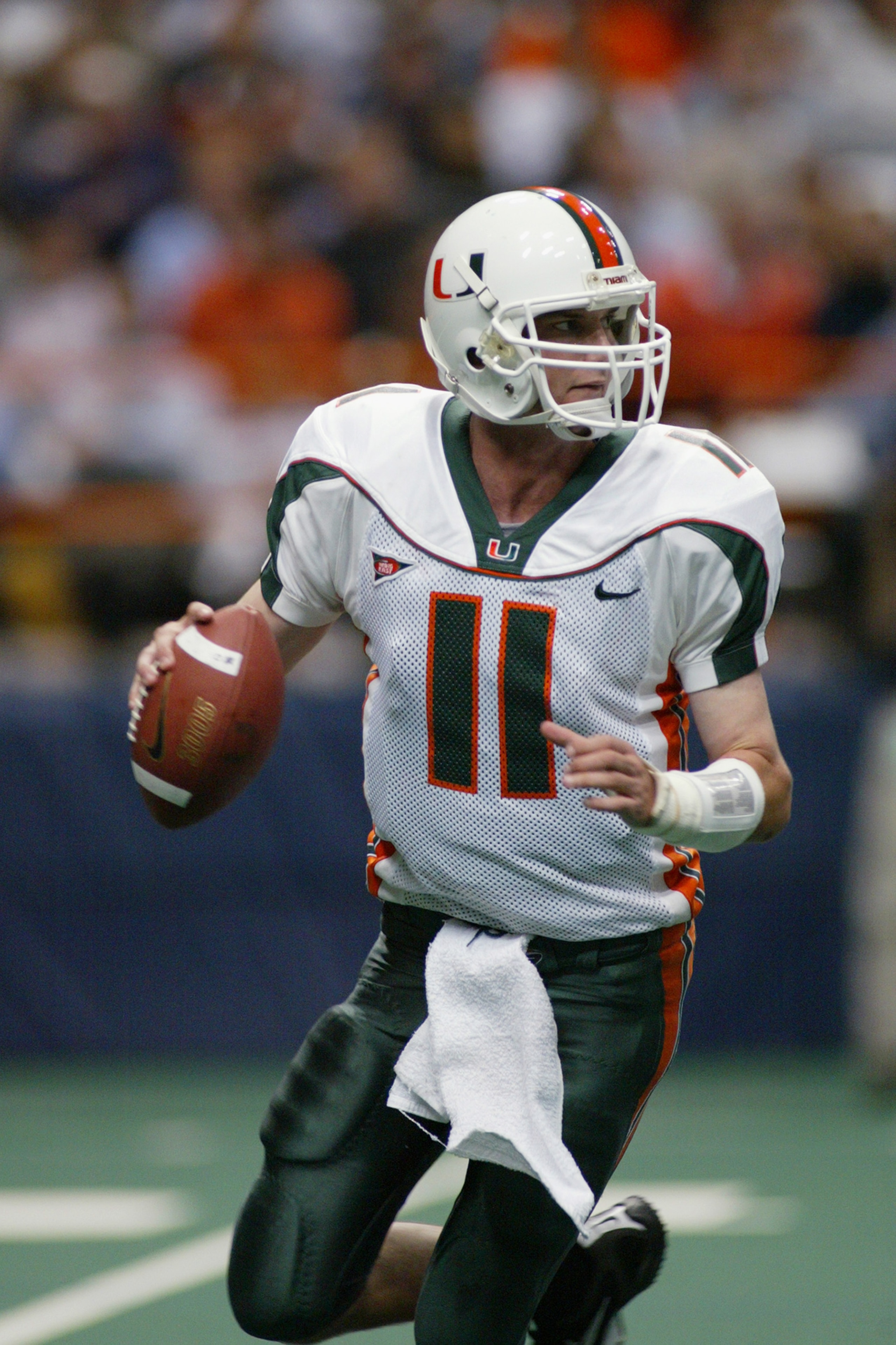 SYRACUSE, NY - NOVEMBER 30:  Ken Dorsey #11 of the University of Miami rolls out to pass during the game against Syracuse University at the Carrier Dome on November 30, 2002 in Syracuse, New York.  Miami won 49-7.  (Photo by Rick Stewart/Getty Images)