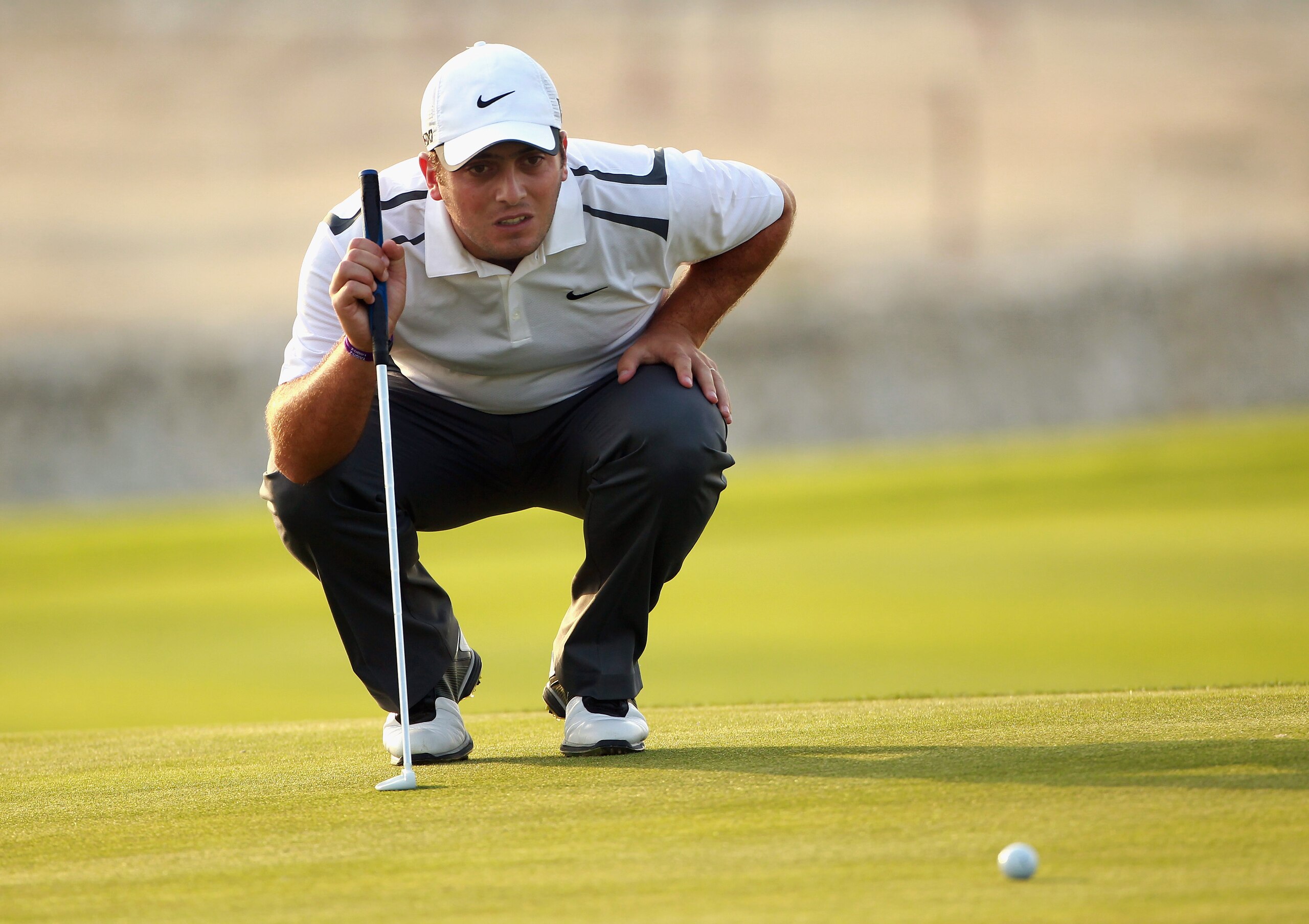 BAHRAIN, BAHRAIN - JANUARY 27:  Francesco Molinari of Italy lines up a putt on the 17th hole during the first round of the Volvo Golf Champions at The Royal Golf Club on January 27, 2011 in Bahrain, Bahrain.  (Photo by Andrew Redington/Getty Images)