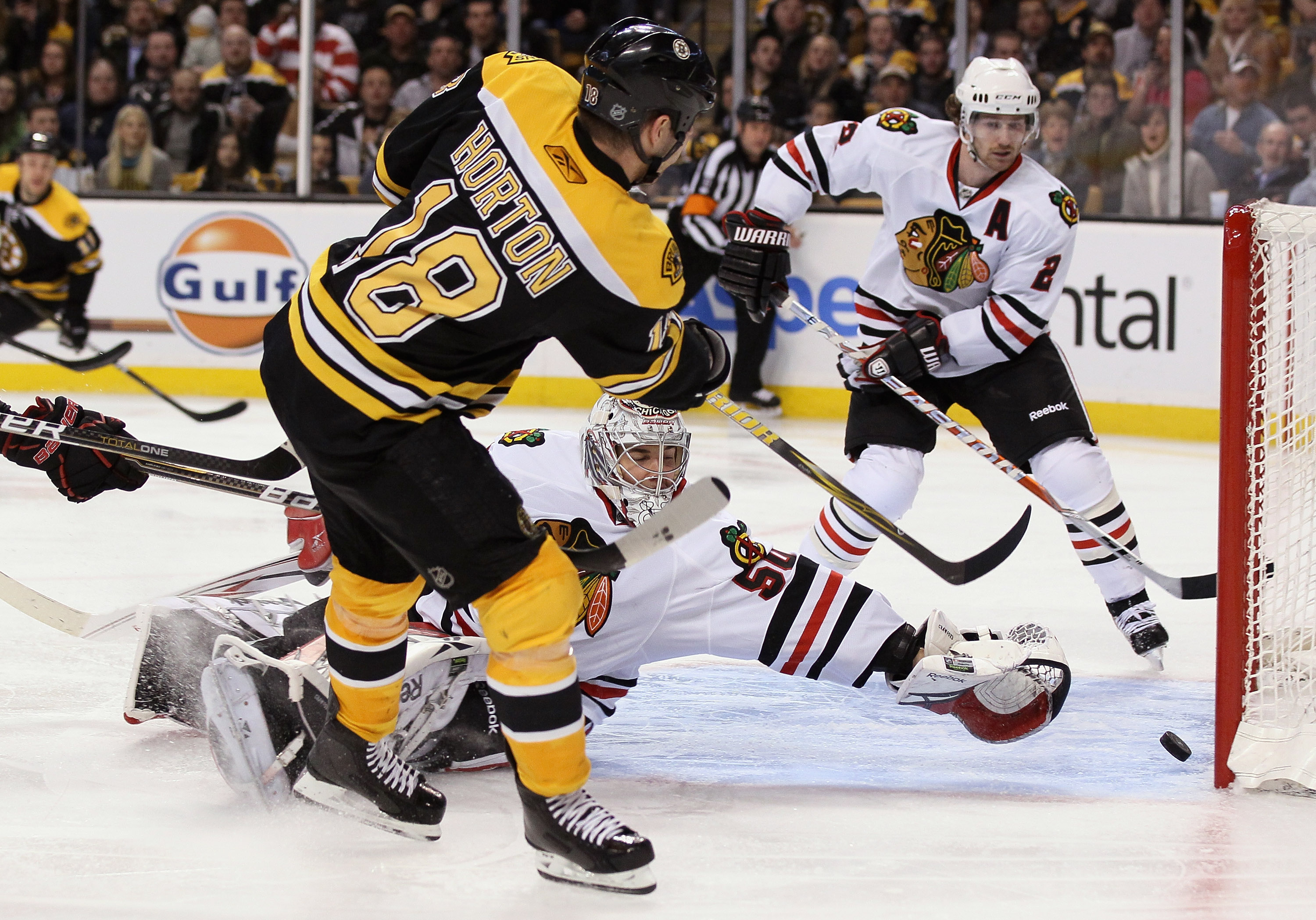 BOSTON, MA - MARCH 29:  Nathan Horton #18 of the Boston Bruins gets the puck past Corey Crawford #50 of the Chicago Blackhawks in the third period on March 29, 2011 at the TD Garden in Boston, Massachusetts. The Boston Bruins defeated the Chicago Blackhaw