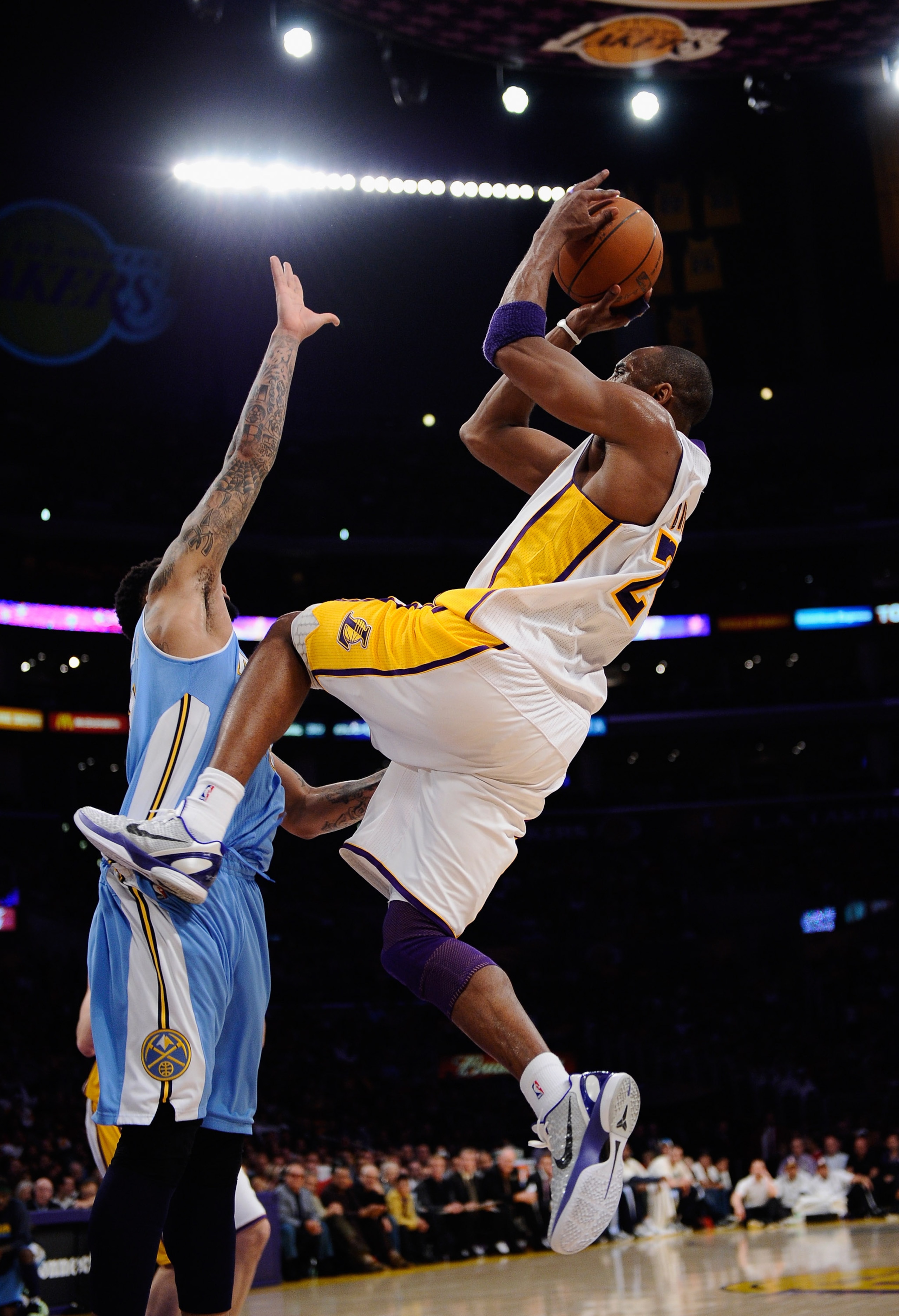 LOS ANGELES, CA - APRIL 03:  Kobe Bryant #24 of the Los Angeles Lakers shoots a basket over Wilson Chandler #21 during the NBA basketball game at Staples Center on April 3, 2011 in Los Angeles, California. NOTE TO USER: User expressly acknowledges and agr