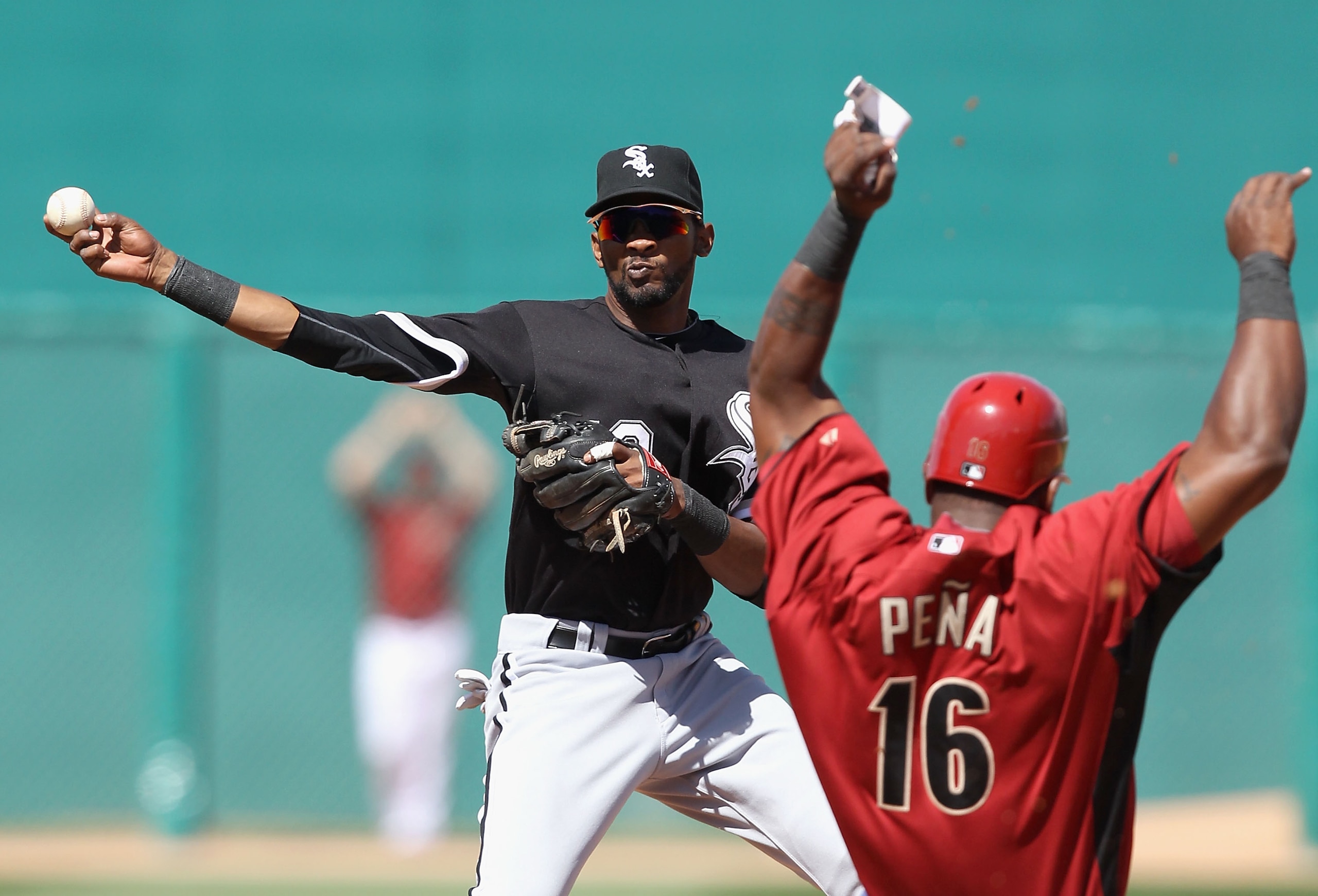 TUCSON, AZ - MARCH 07:  Infielder Alexei Ramirez #10 of the Chicago White Sox throws over the sliding Wily Mo Pena #16 of the Arizona Diamondbacks attempting a double play during the second inning of the spring training game at Kino Veterans Memorial Stad
