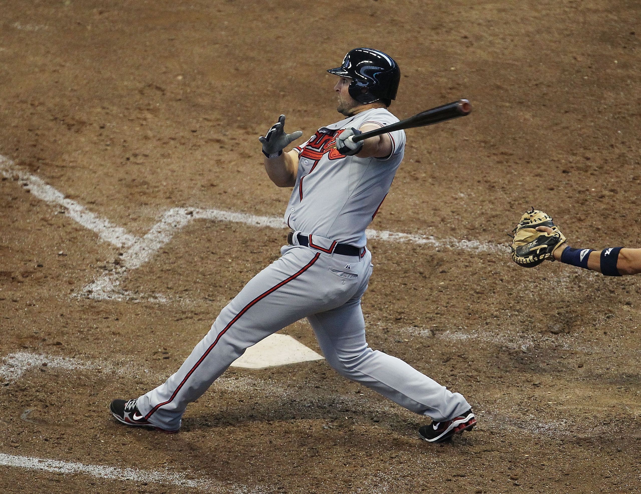 MILWAUKEE, WI - APRIL 04: Dan Uggla #26 of the Atlanta Braves hits a solo home run in the 8th inning against the Milwaukee Brewers during the home opener at Miller Park on April 4, 2011 in Milwaukee, Wisconsin. The Braves defeated the Brewers 2-1. (Photo