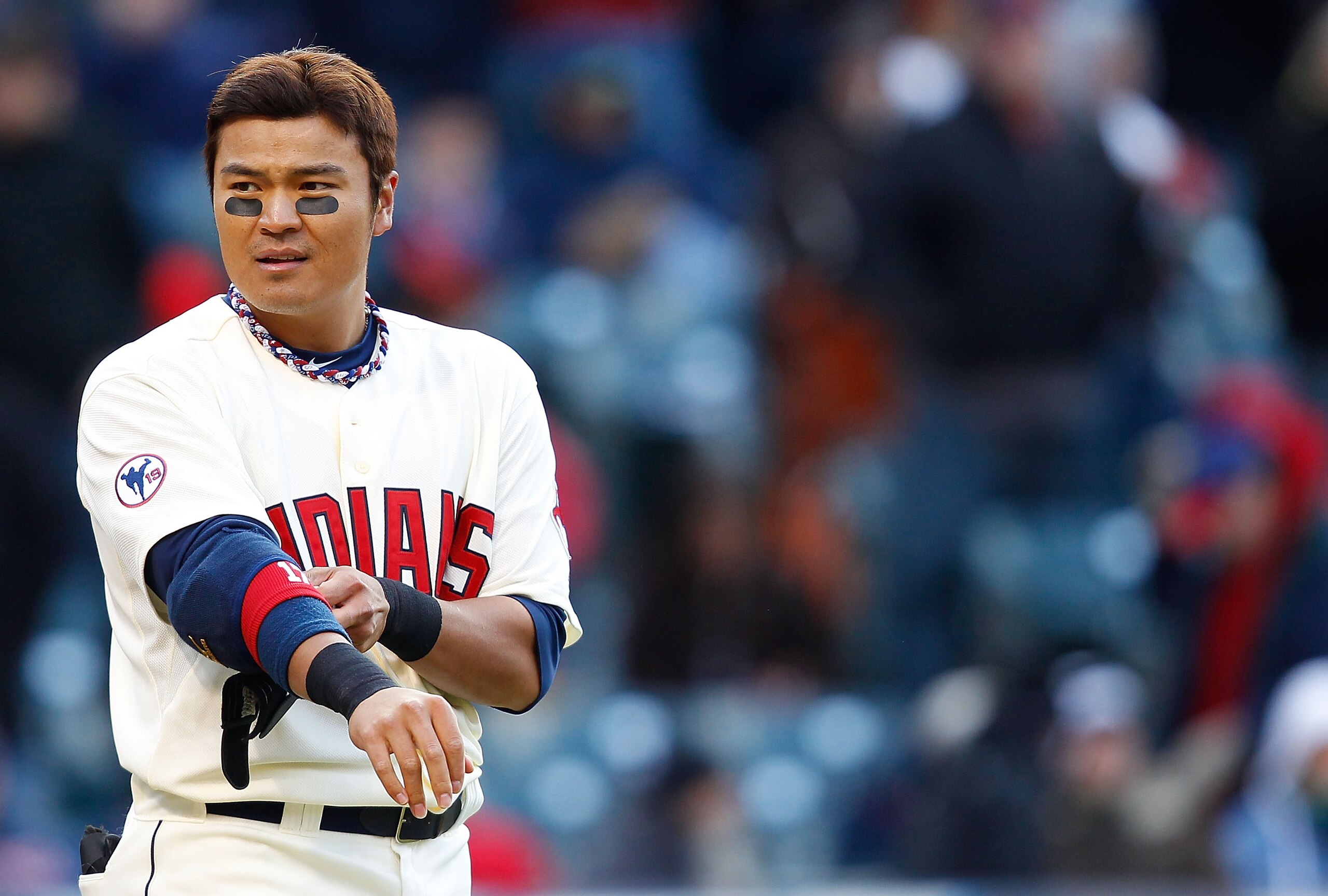 CLEVELAND - APRIL 01:  Shin-Soo Choo #17 of the Cleveland Indians removes his elbow pads inbetween innings during the Opening Day game against the Chicago White Sox on April 1, 2011 at Progressive Field in Cleveland, Ohio.  (Photo by Jared Wickerham/Getty