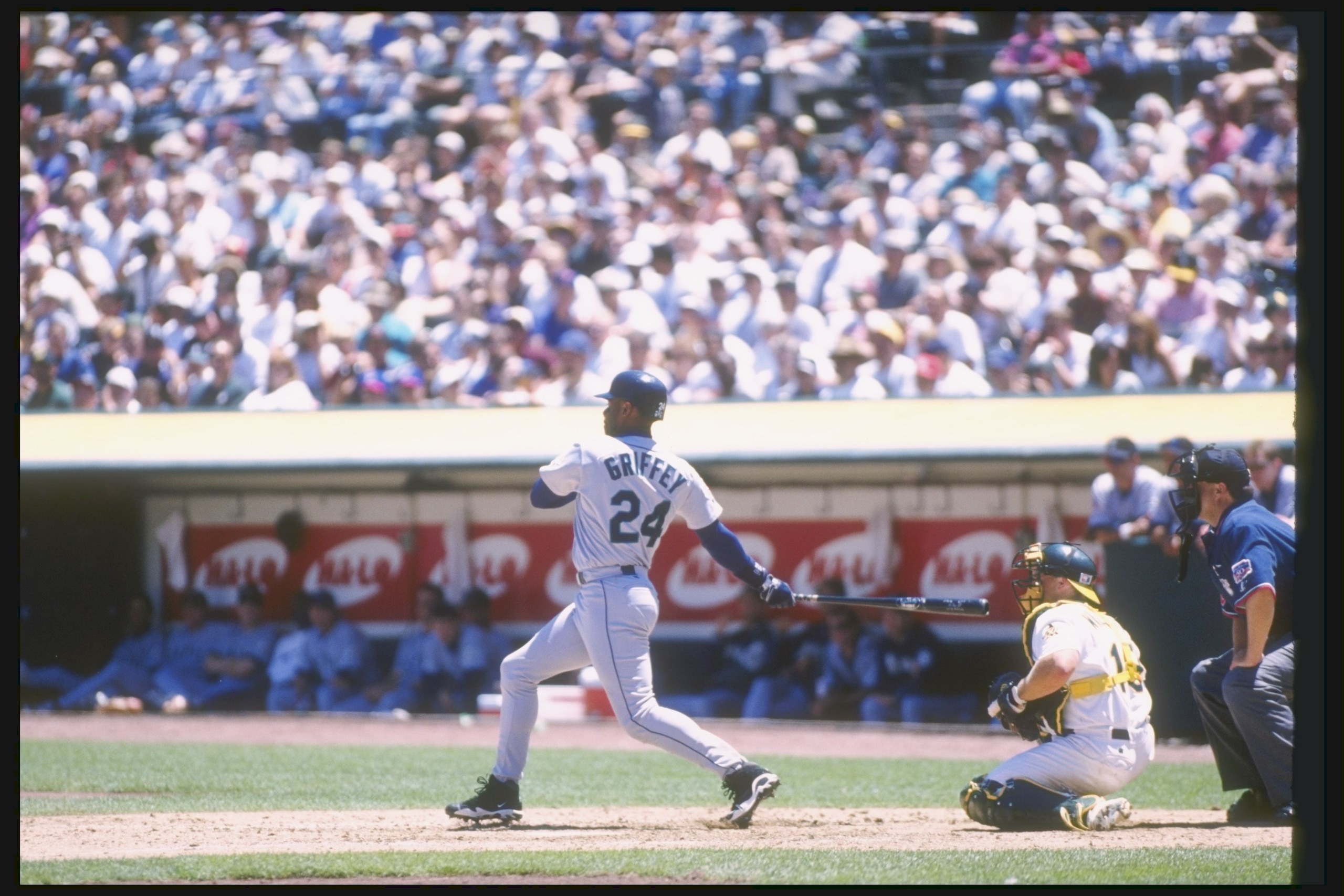 15 Jul 1997: Center fielder Ken Griffey Jr. of the Seattle Mariners swings at the ball during a game against the Oakland Athletics at the Oakland Coliseum in Oakland, California. The Athletics won the game 8-5.