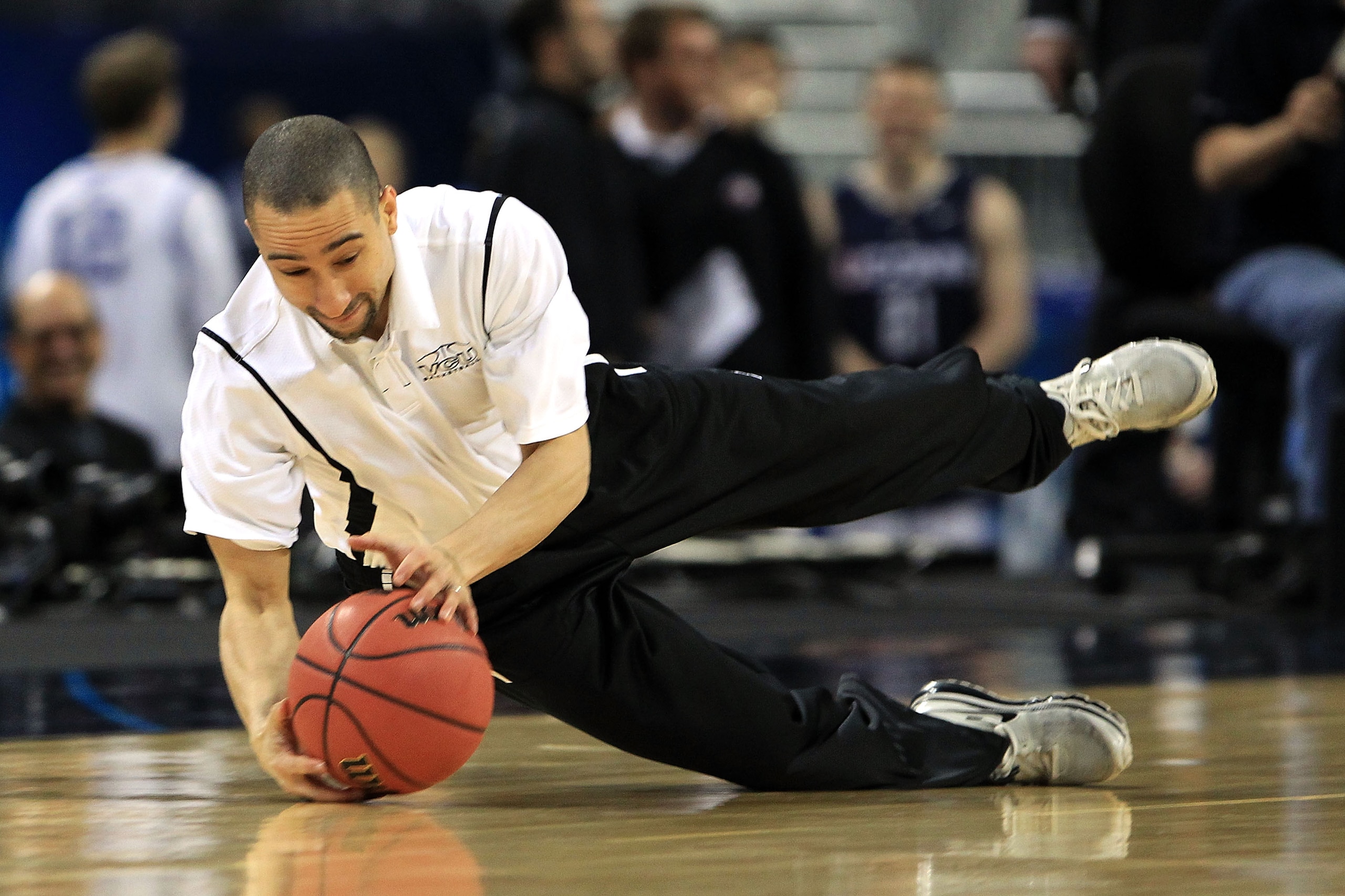 HOUSTON, TX - APRIL 01:  Head coach Shaka Smart of the Virginia Commonwealth Rams dives for the ball during a drill at practice prior to the 2011 Final Four of the NCAA Division I Men's Basketball Tournament at Reliant Stadium on April 1, 2011 in Houston,