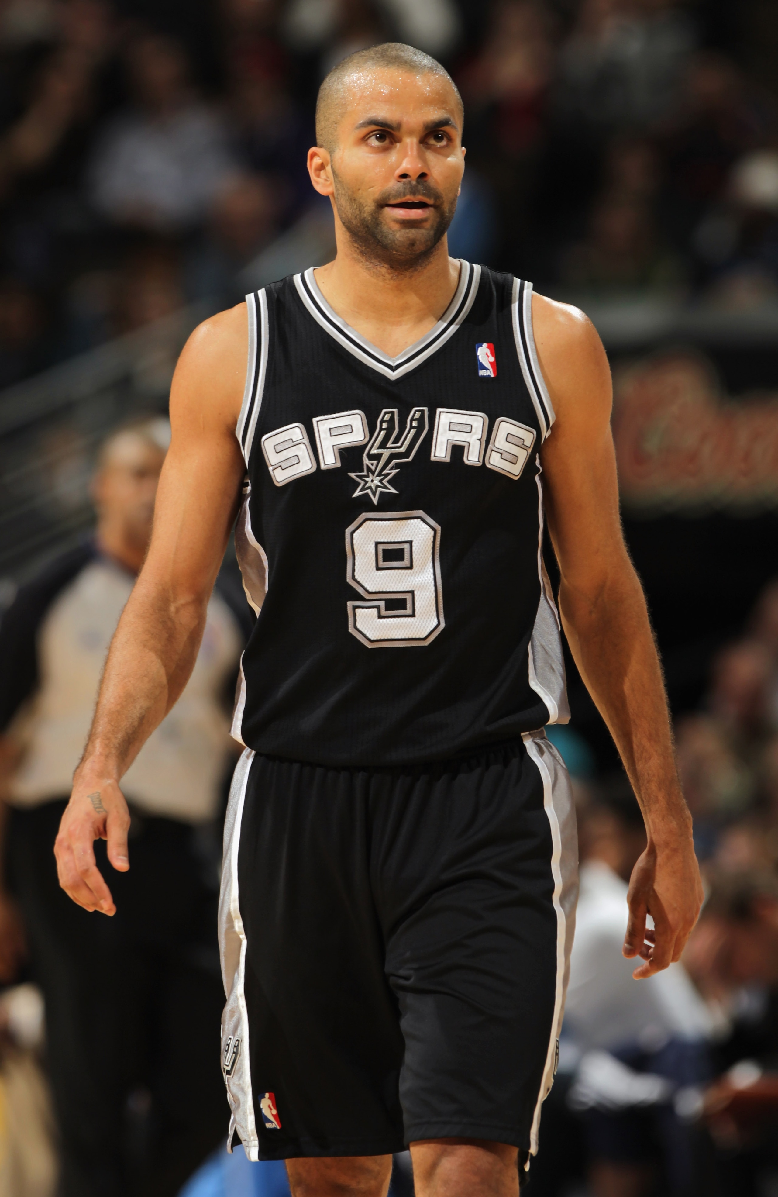 DENVER, CO - MARCH 23: Tony Parker #9 of the San Antonio Spurs looks on during a break in the against the Denver Nuggets at the Pepsi Center on March 23, 2011 in Denver, Colorado. The Nuggets defeated the Spurs 115-112. NOTE TO USER: User expressly ackno DENVER, CO - MARCH 23: Tony Parker #9 of the San Antonio Spurs looks on during a break in the against the Denver Nuggets at the Pepsi Center on March 23, 2011 in Denver, Colorado. The Nuggets defeated the Spurs 115-112. NOTE TO USER: User expressly ackno