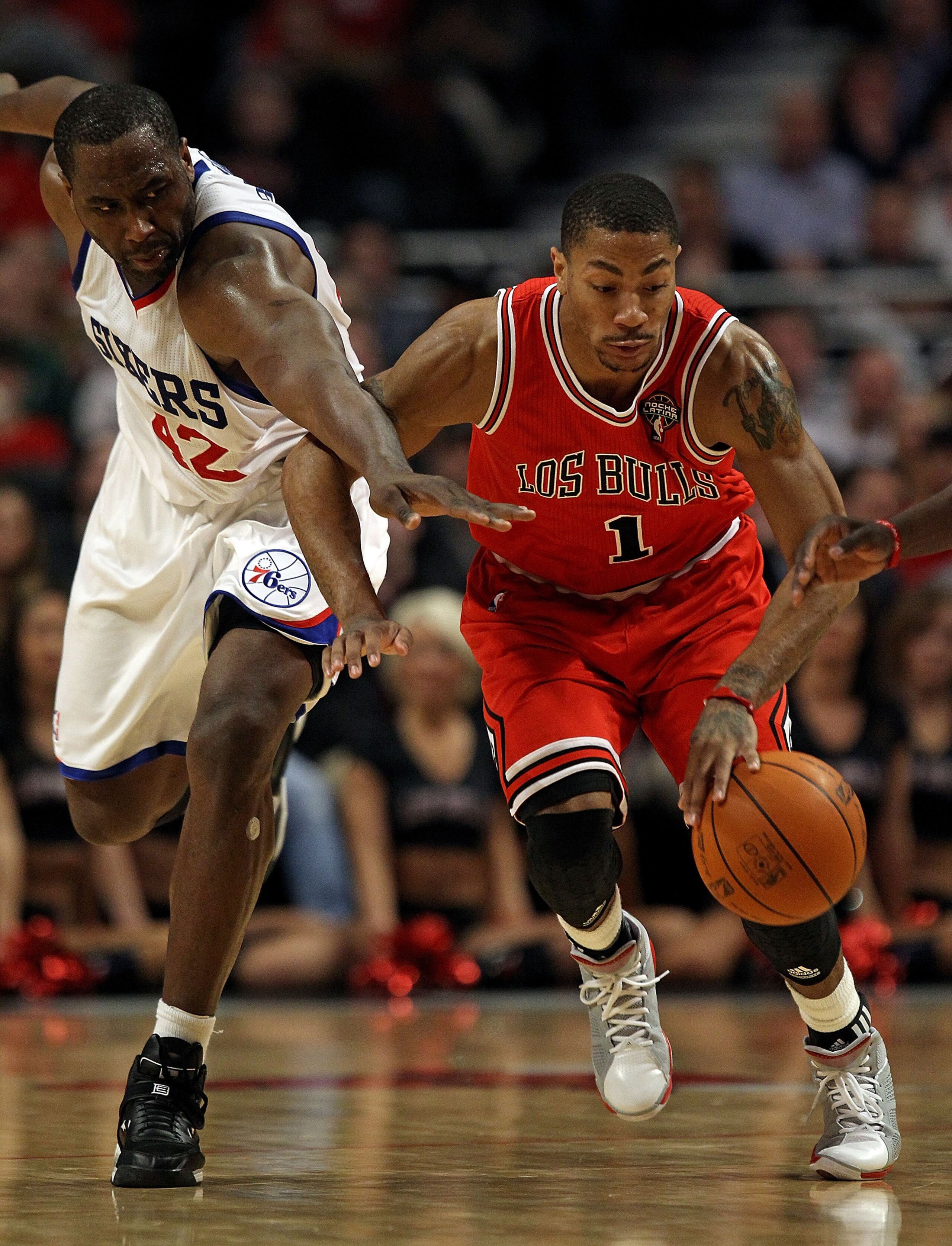 CHICAGO, IL - MARCH 28: Derrick Rose #1 of the Chicago Bulls and Elton Brand #42 of the Philadelphia 76ers chase down a loose ball at the United Center on March 28, 2011 in Chicago, Illinois. The 76ers defeated the Bulls 97-85. NOTE TO USER: User expressl CHICAGO, IL - MARCH 28: Derrick Rose #1 of the Chicago Bulls and Elton Brand #42 of the Philadelphia 76ers chase down a loose ball at the United Center on March 28, 2011 in Chicago, Illinois. The 76ers defeated the Bulls 97-85. NOTE TO USER: User expressl