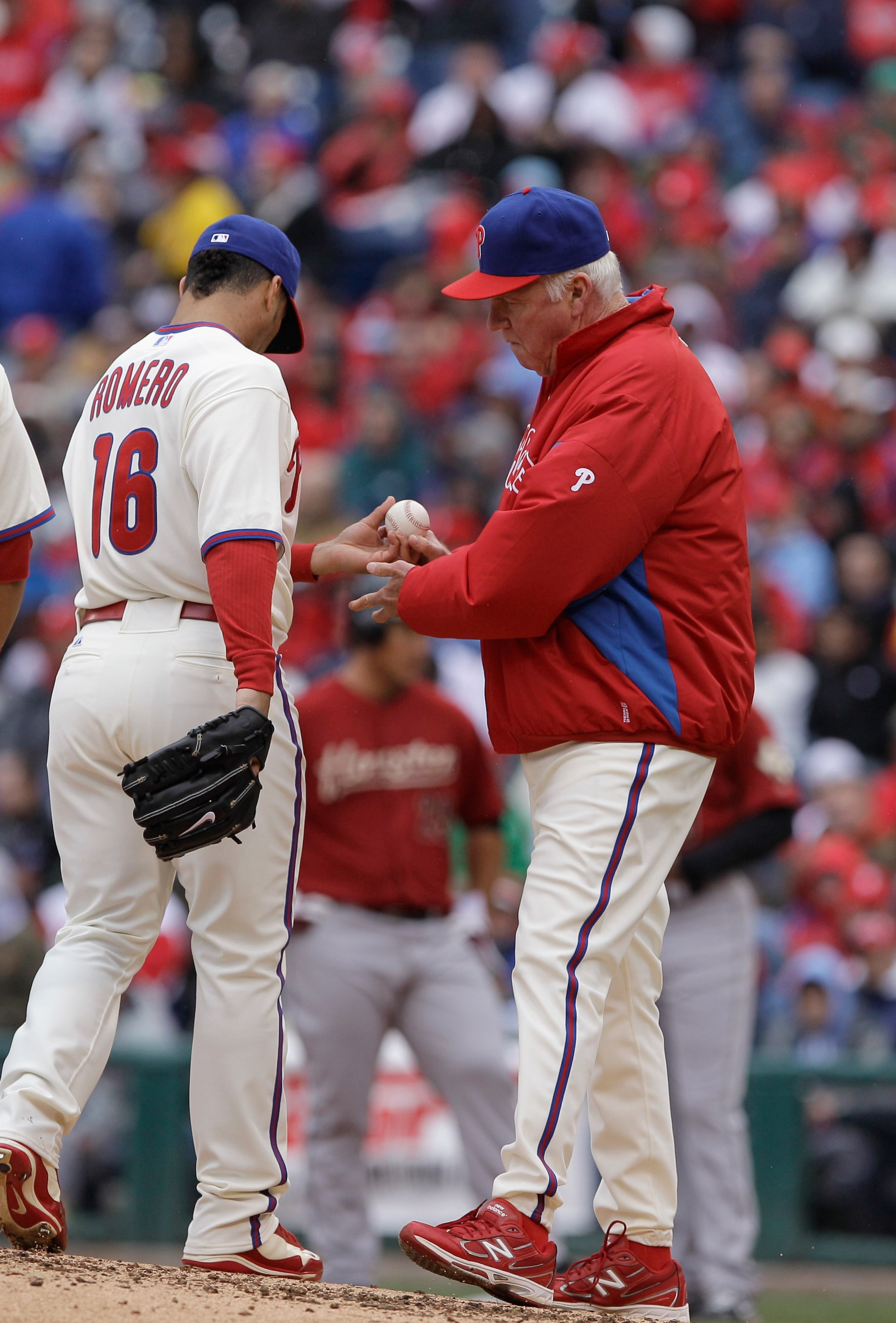 PHILADELPHIA, PA - APRIL 01:  Manager Charlie Manuel #41 of the Philadelphia Phillies removes reliever J.C. Romero #16 during a pitching change against the Houston Astros during opening day at Citizens Bank Park on April 1, 2011 in Philadelphia, Pennsylva