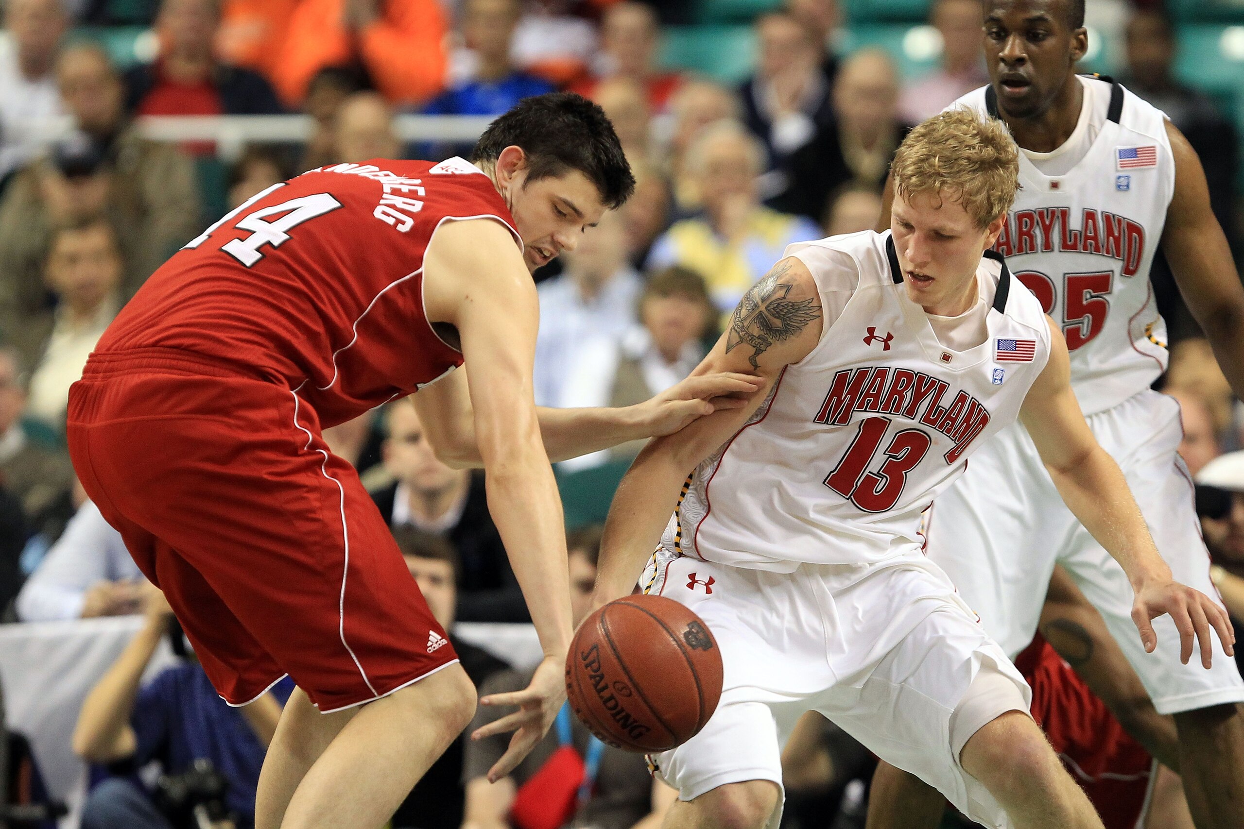 GREENSBORO, NC - MARCH 10:  Jordan Vandenberg #14 of the North Carolina State Wolfpack fights for possession of the ball against Haukur Palsson #13 of the Maryland Terrapins during the first half of the game in the first round of the 2011 ACC men's basket