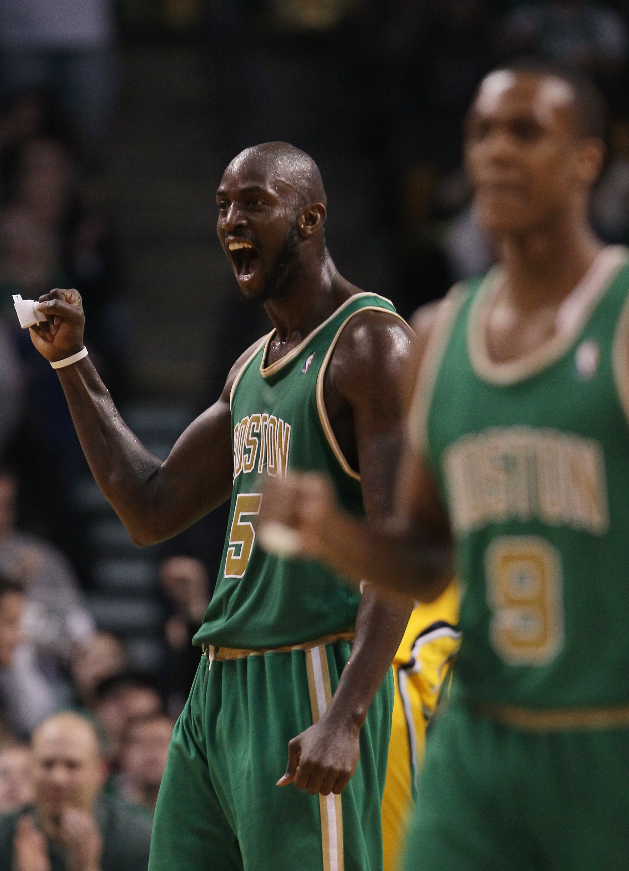 BOSTON, MA - MARCH 16:  Kevin Garnett #5 and Rajon Rondo #9 of the Boston Celtics celebrate after teammate Ray Allen drew the foul in the second half against the Indiana Pacers on March 16, 2011 at the TD Garden in Boston, Massachusetts. The Celtics defea