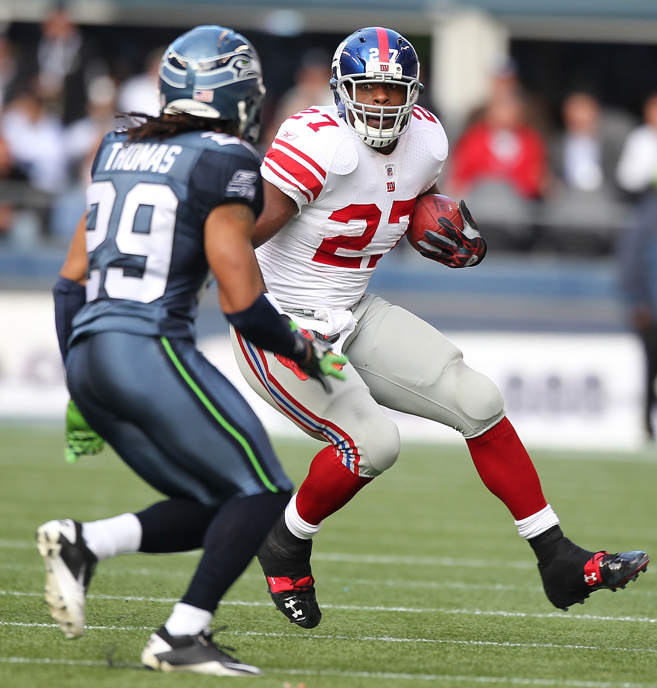 SEATTLE - NOVEMBER 07:  Running back Brandon Jacobs #27 of the New York Giants rushes against Earl Thomas #29 of the Seattle Seahawks at Qwest Field on November 7, 2010 in Seattle, Washington. (Photo by Otto Greule Jr/Getty Images)