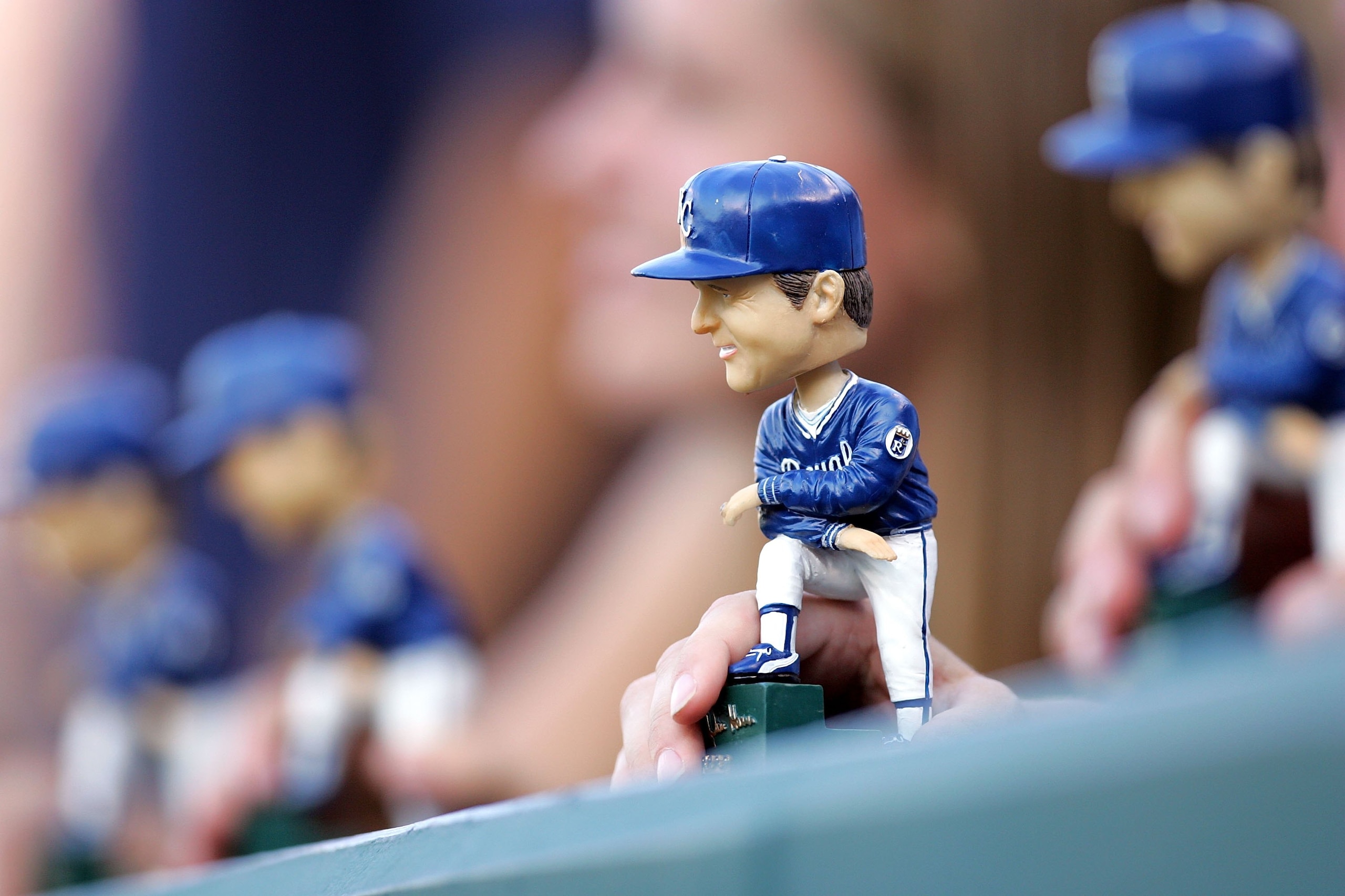 KANSAS CITY, MO - JULY 22:  A fan displays a bobblehead of former manager Dick Howser of the Kansas City Royals during the game between the Royals and the Los Angeles Angels of Anaheim on Dick Howser bobblehead giveaway night on July 22, 2006 at Kauffman