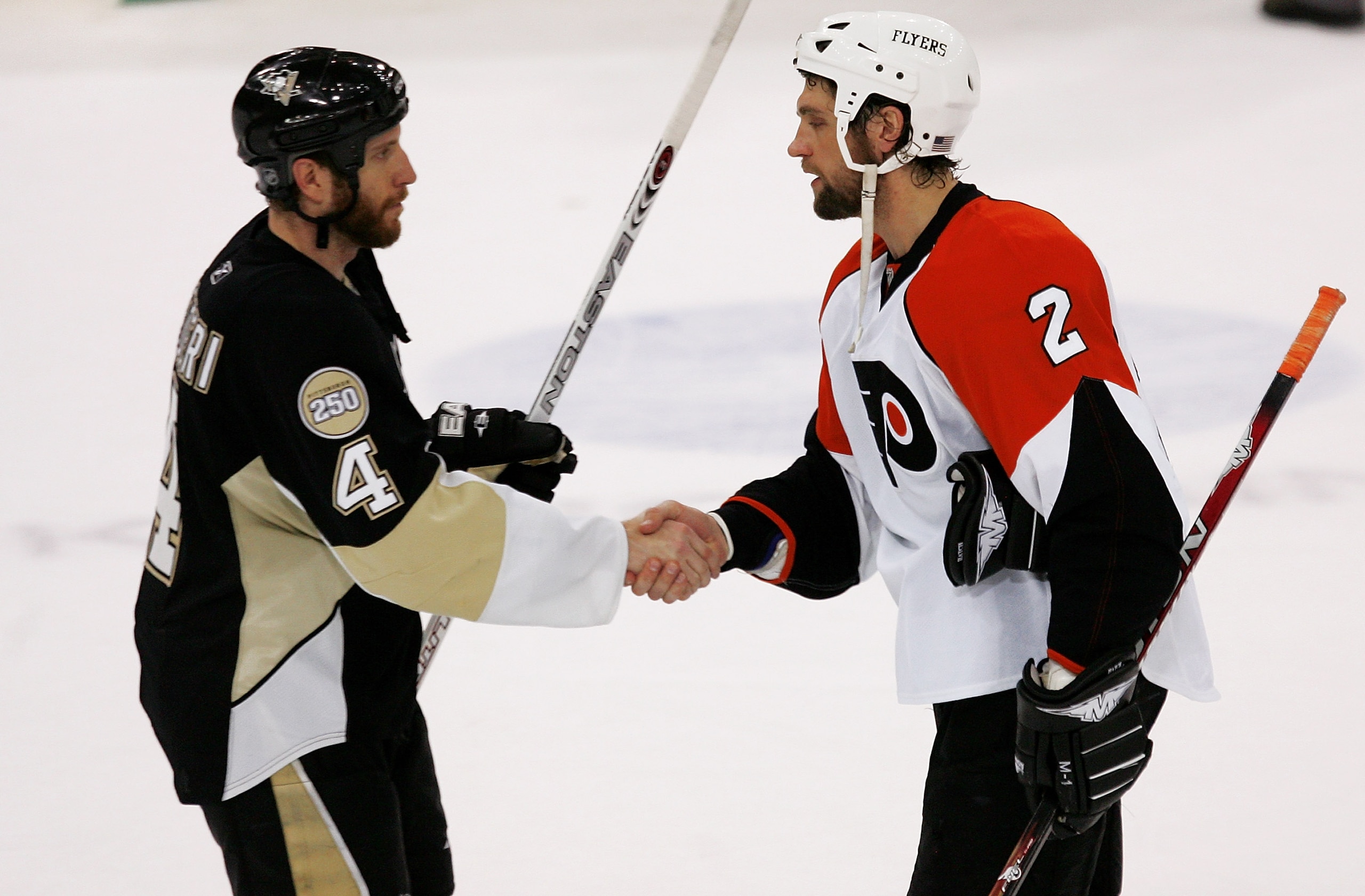 PITTSBURGH - MAY 18:  Rob Scuderi #4 of the Pittsburgh Penguins is congratulated by Derian Hatcher #2 of the Philadelphia Flyers after the Penguins shut out the Flyers 6-0 to win game five of the Eastern Conference Finals of the 2008 NHL Stanley Cup Playo