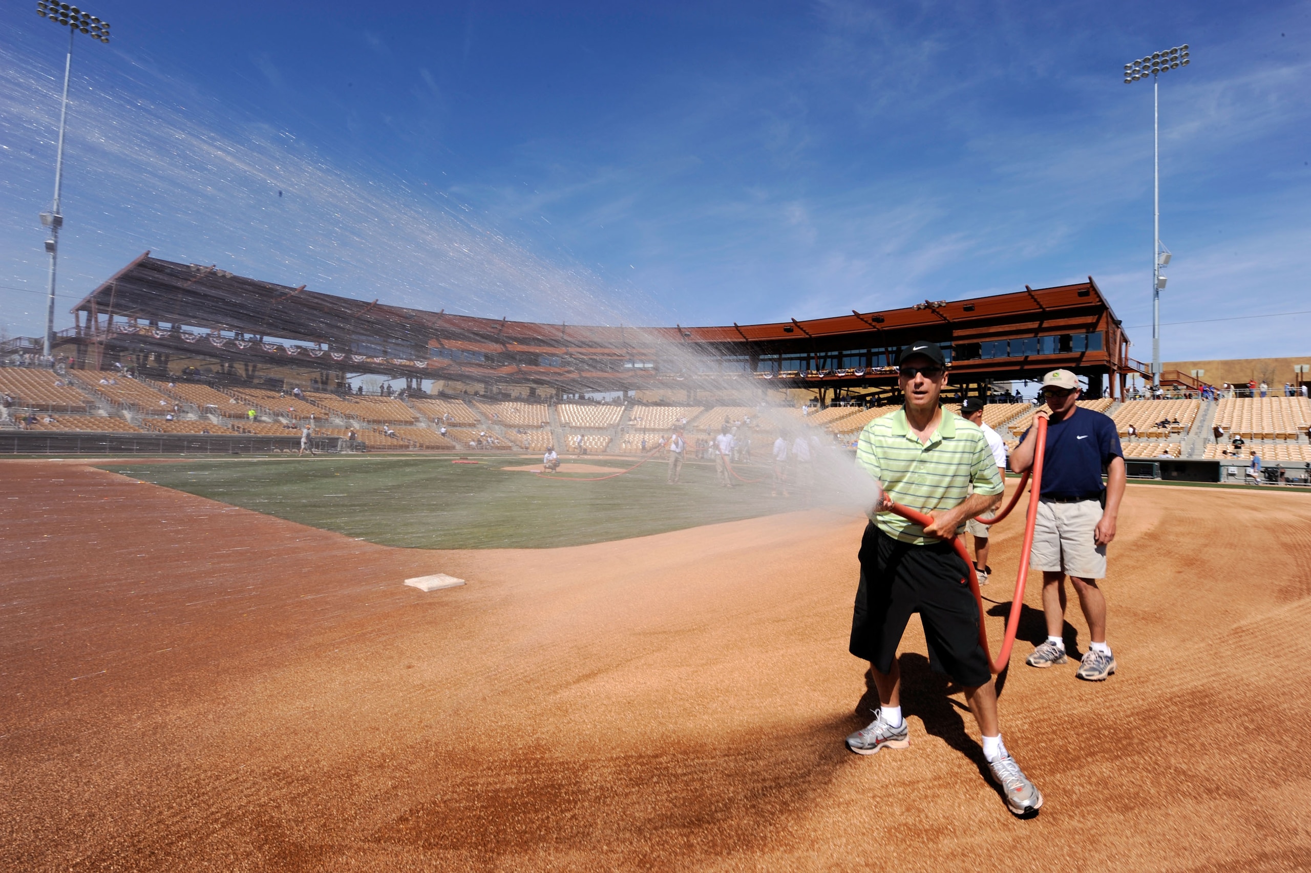 GLENDALE, AZ - MARCH 01:  Chicago White Sox head grounds keeper Roger Bossard wets the infield prior to the start of Los Angeles Dodgers home opener against the White Sox at Camelback Ranch March 1, 2009 in Glendale, Arizona.  (Photo by Kevork Djansezian/