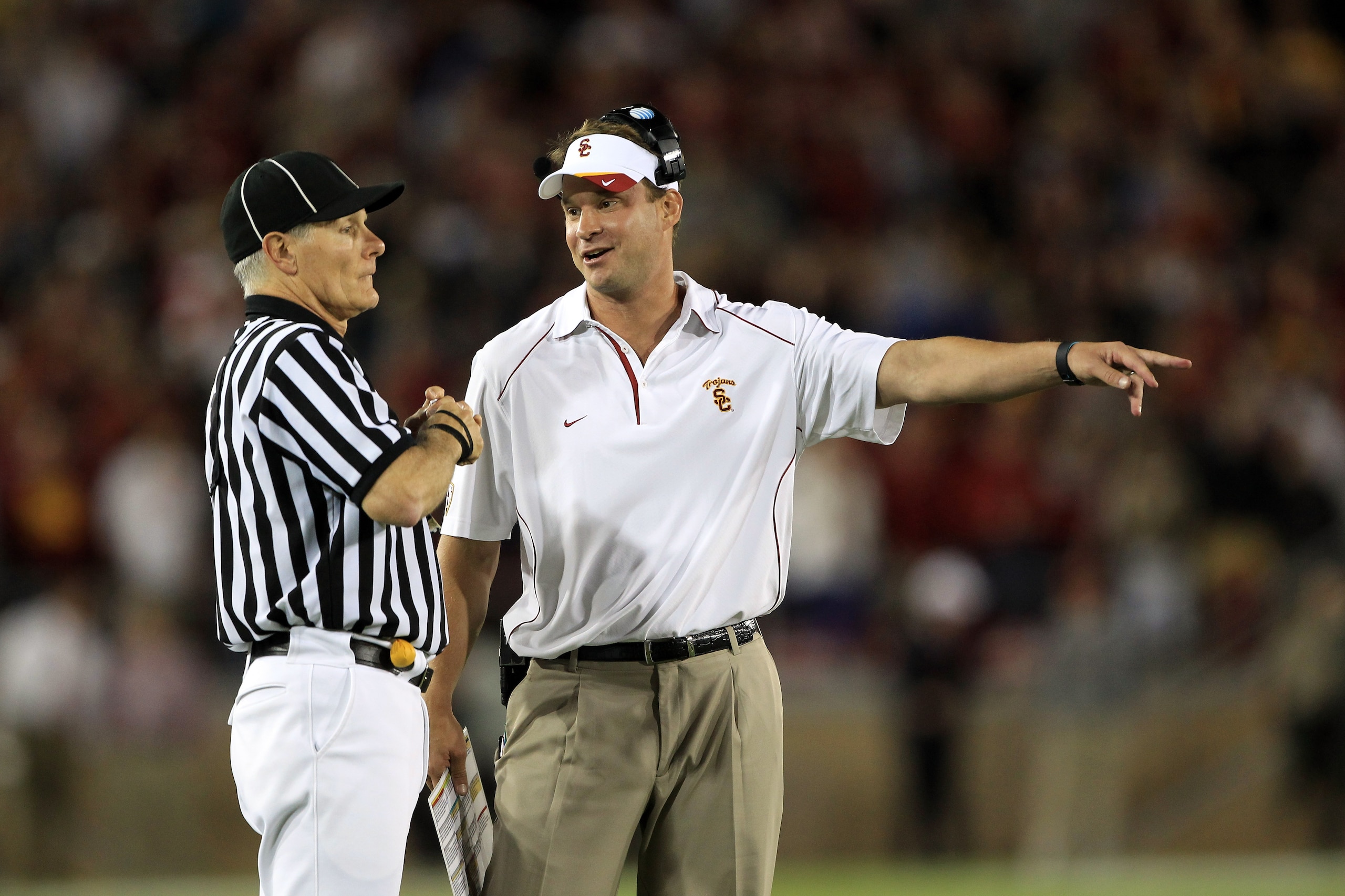 PALO ALTO, CA - OCTOBER 09:  USC Trojans head coach Lane Kiffin speaks with side judge Mike Weseloh during their loss to the Stanford Cardinal at Stanford Stadium on October 9, 2010 in Palo Alto, California.  (Photo by Ezra Shaw/Getty Images)