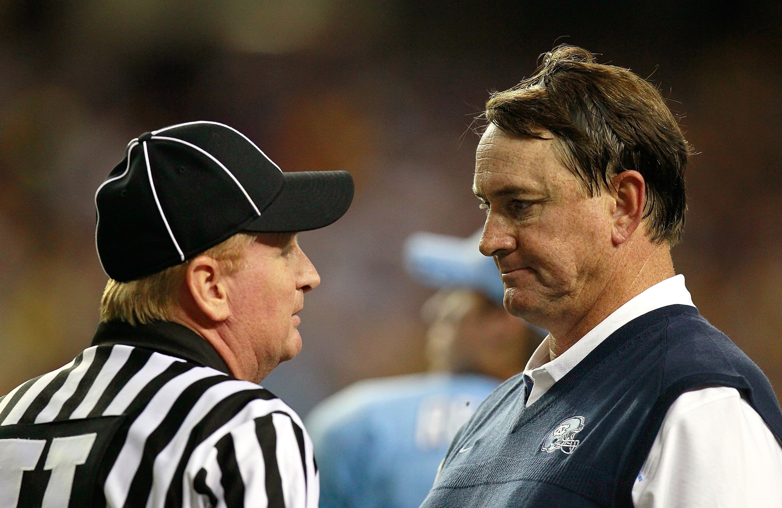 ATLANTA - SEPTEMBER 04:  Head coach Butch Davis of the North Carolina Tar Heels and Umpire Brent Sowell during the game against the LSU Tigers in the Chick-fil-A Kickoff Game at Georgia Dome on September 4, 2010 in Atlanta, Georgia.  (Photo by Kevin C. Co