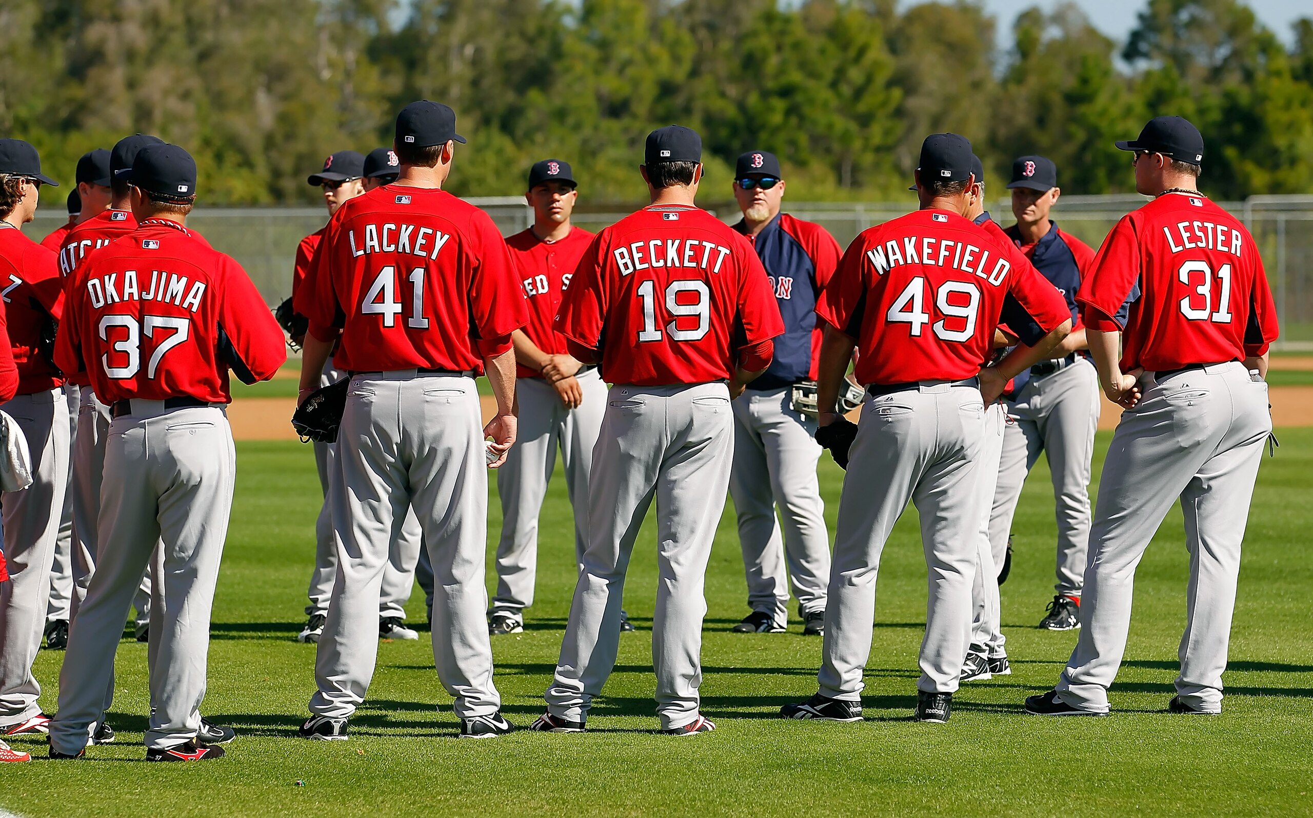 FORT MYERS, FL - FEBRUARY 19:  Pitchers Hideki Okajima #37, John Lackey #41, Josh Beckett #19, Tim Wakefield #49 and Jon Lester #31 of the Boston Red Sox talk with coaches during a Spring Training Workout Session at the Red Sox Player Development Complex