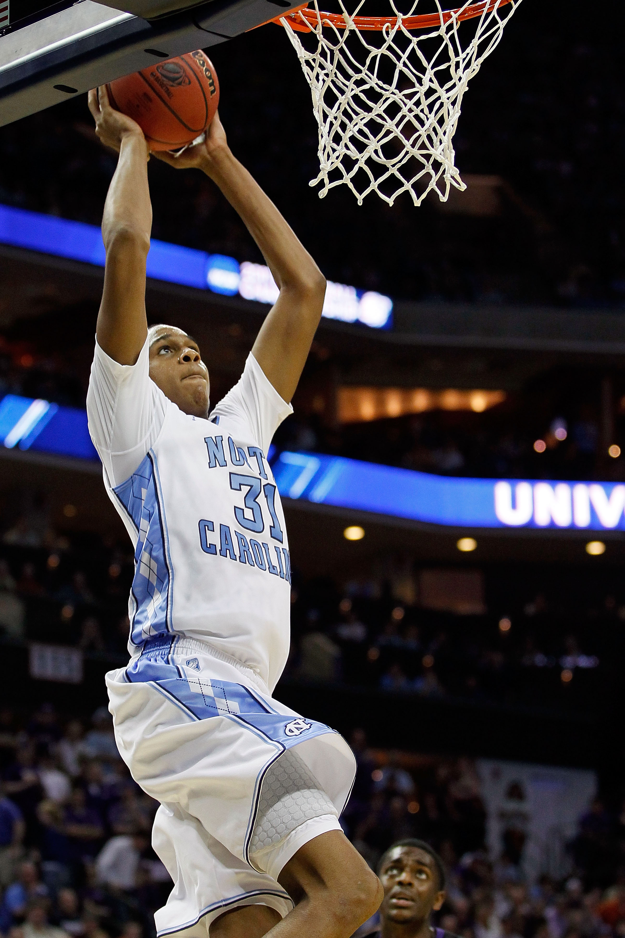 CHARLOTTE, NC - MARCH 20:  John Henson #31 of the North Carolina Tar Heels goes up to dunk the ball while taking on the Michigan Wolverines during the third round of the 2011 NCAA men's basketball tournament at Time Warner Cable Arena on March 20, 2011 in