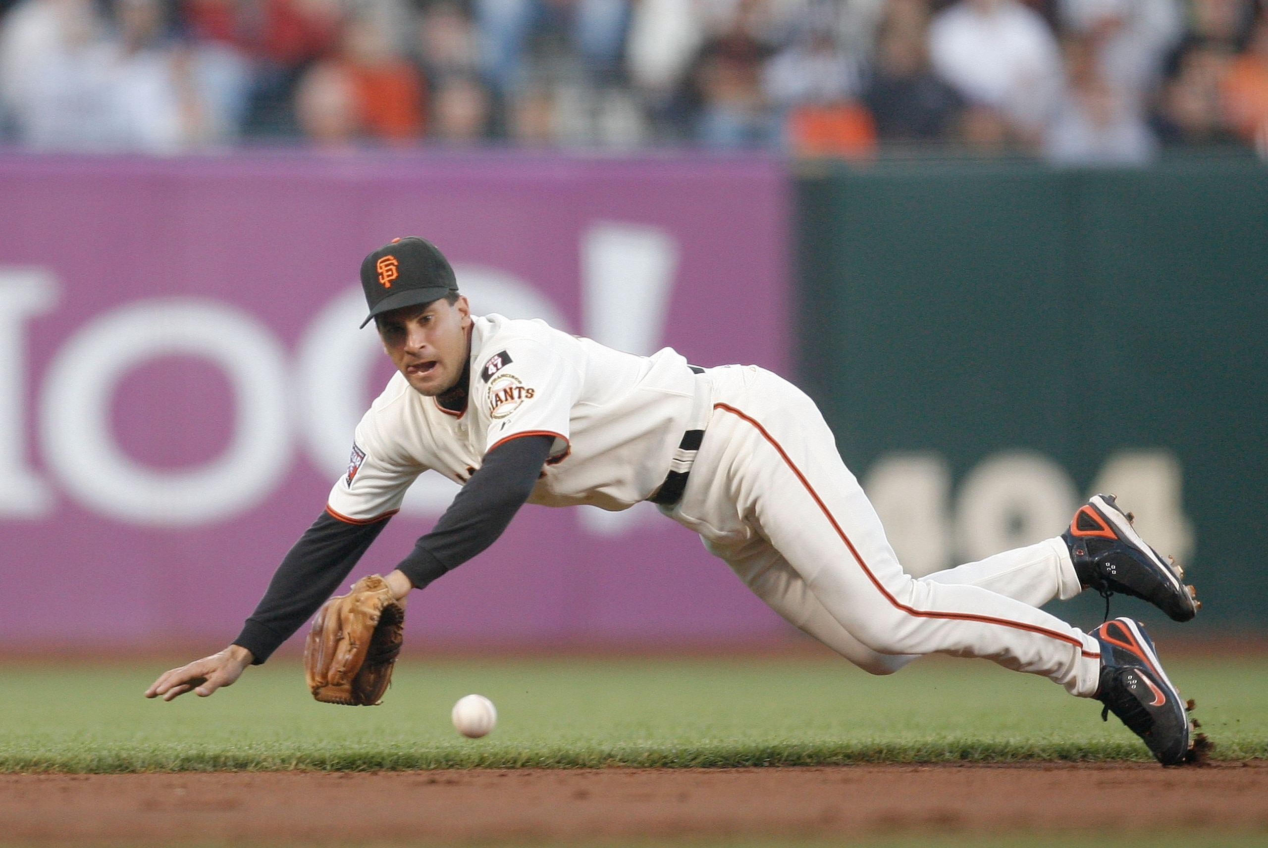 SAN FRANCISCO - AUGUST 21: Shortstop Omar Vizquel #13 of the San Francisco Giants dives for a groundball against the Chicago Cubs during a Major League Baseball game at AT&T Park on August 21, 2007 in San Francisco, California.  (Photo by Greg Trott/Getty