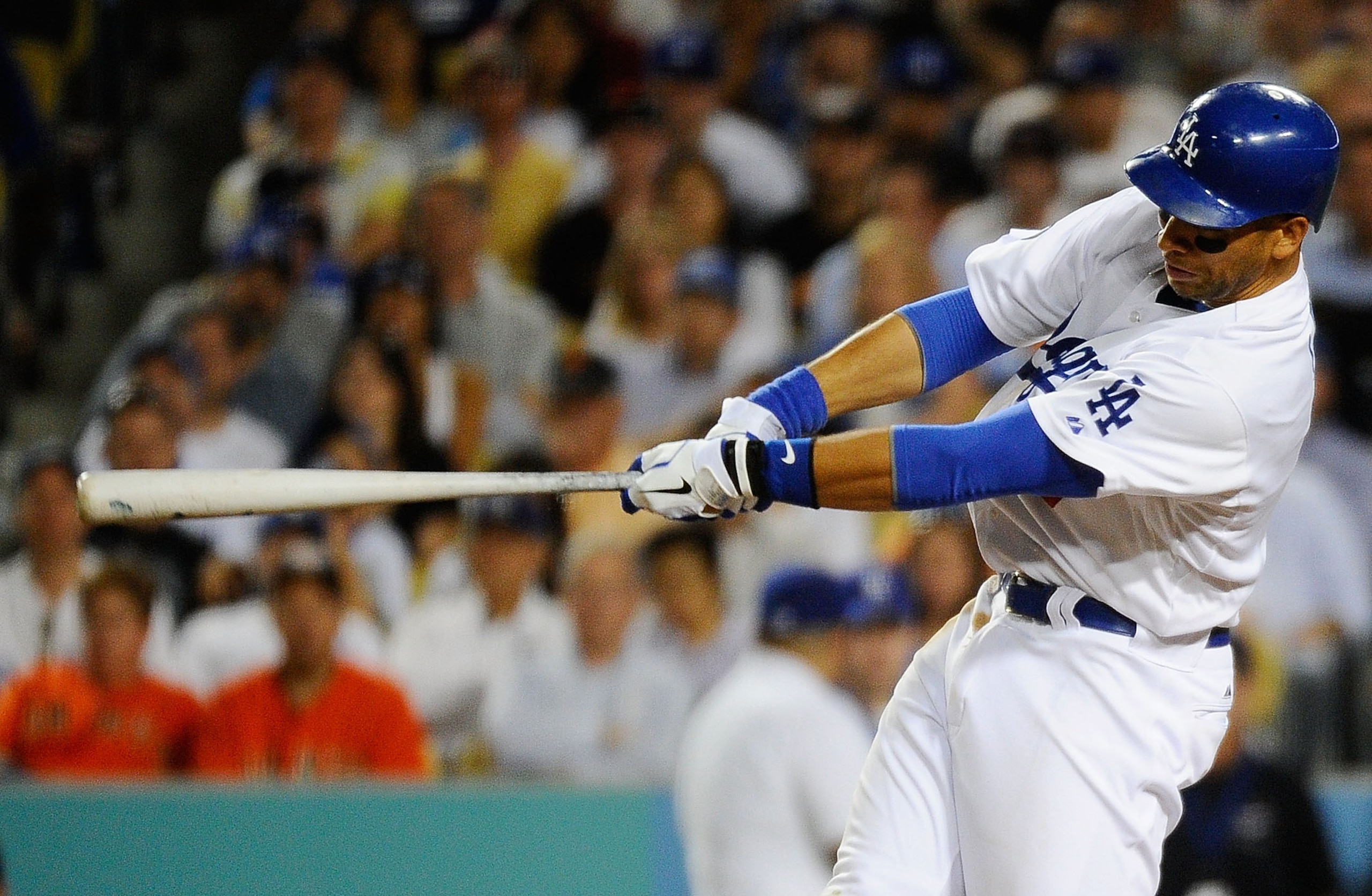LOS ANGELES, CA - MARCH 31:  James Loney #7 of the Los Angeles Dodgers hits a double scoring Matt Kemp #27 in the eighth inning against the San Francisco Giants on Opening Day at Dodger Stadium on March 31, 2011 in Los Angeles, California.  (Photo by Kevo