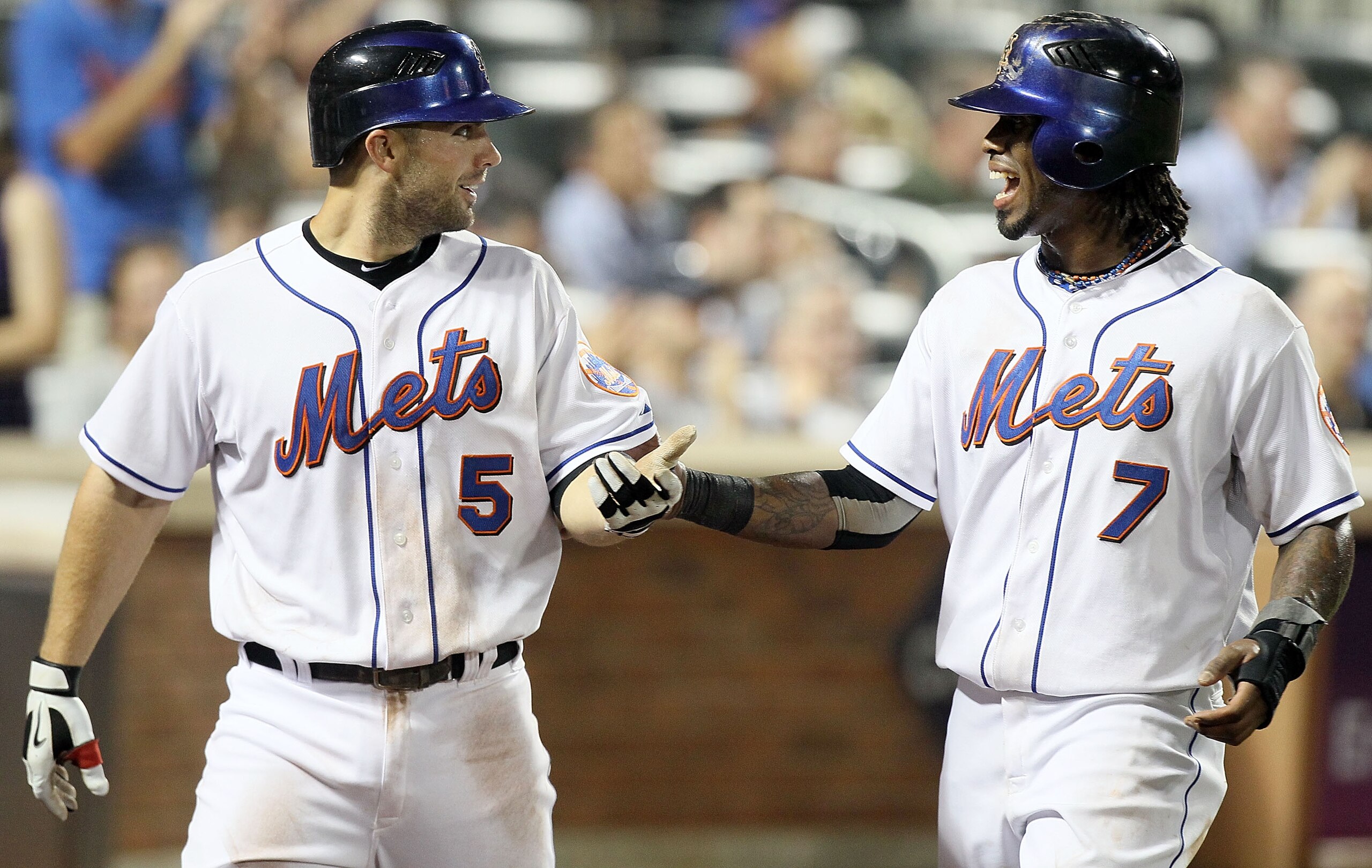 NEW YORK - JULY 06:  Jose Reyes #7 and David Wright #5 of the New York Mets celebrate after scoring in the sixth inning against the Cincinnati Reds on July 6, 2010 at Citi Field in the Flushing neighborhood of the Queens borough of New York City.  (Photo