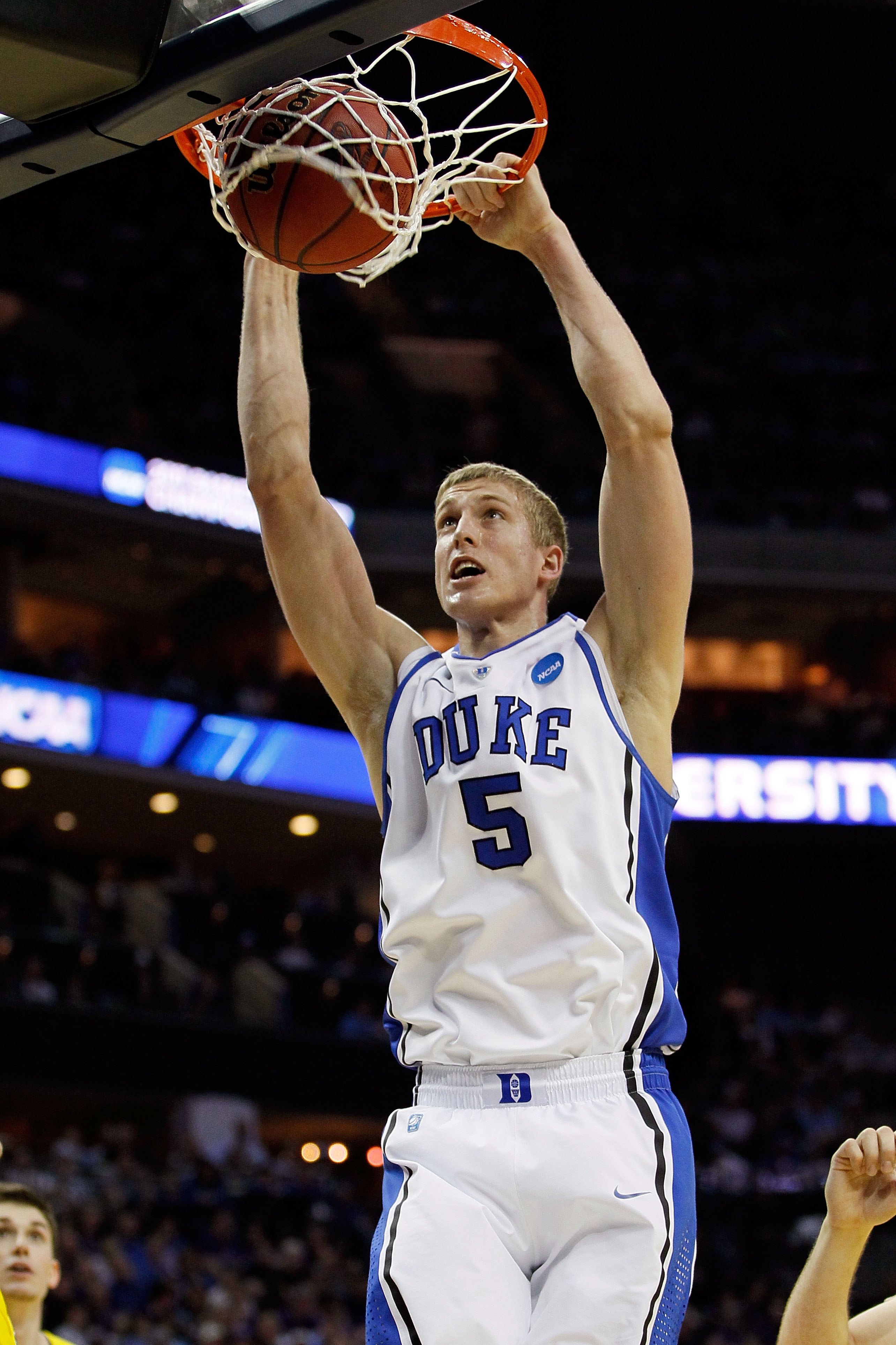 CHARLOTTE, NC - MARCH 20: Mason Plumlee #5 of the Duke Blue Devils dunks the ball in the first half while taking on the Michigan Wolverines  during the third round of the 2011 NCAA men's basketball tournament at Time Warner Cable Arena on March 20, 2011 i