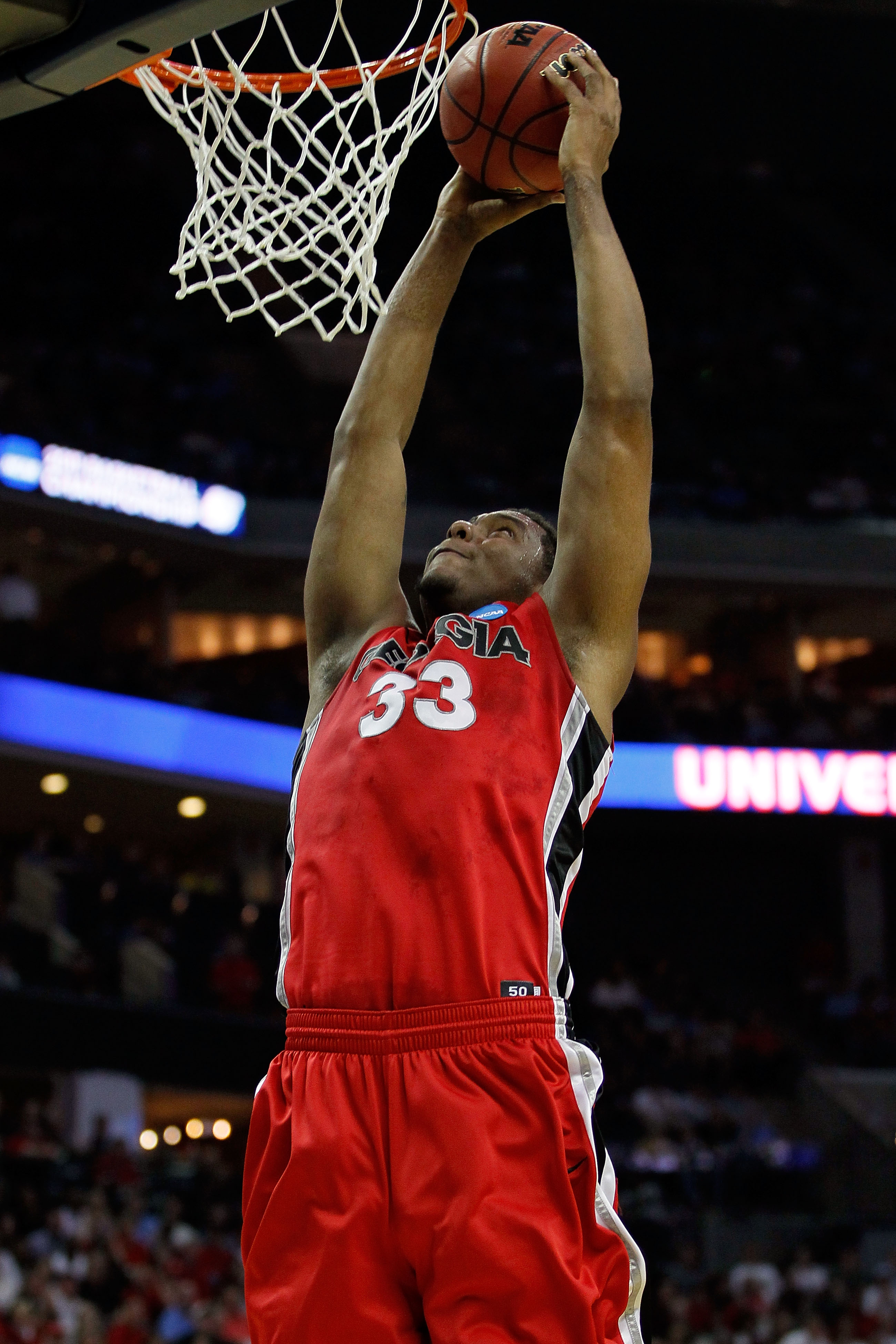 CHARLOTTE, NC - MARCH 18:  Trey Thompkins #33 of the Georgia Bulldogs dunks the ball in the first half while taking on the Washington Huskies during the second round of the 2011 NCAA men's basketball tournament at Time Warner Cable Arena on March 18, 2011