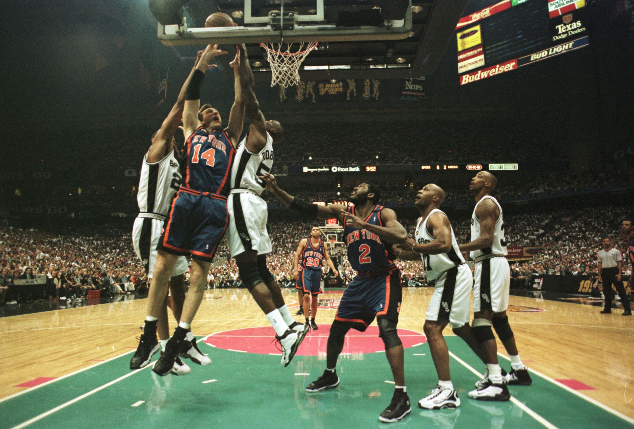 18 Jun 1999: Chris Dudley #14 of the New York Knicks gets hammered as he goes to the basket by Tim Duncan #21 and David Robinson #50 of the San Antonio Spurs during game two of the NBA Finals at the Alamodome in San Antonio, Texas. Mandatory Credit: Matth
