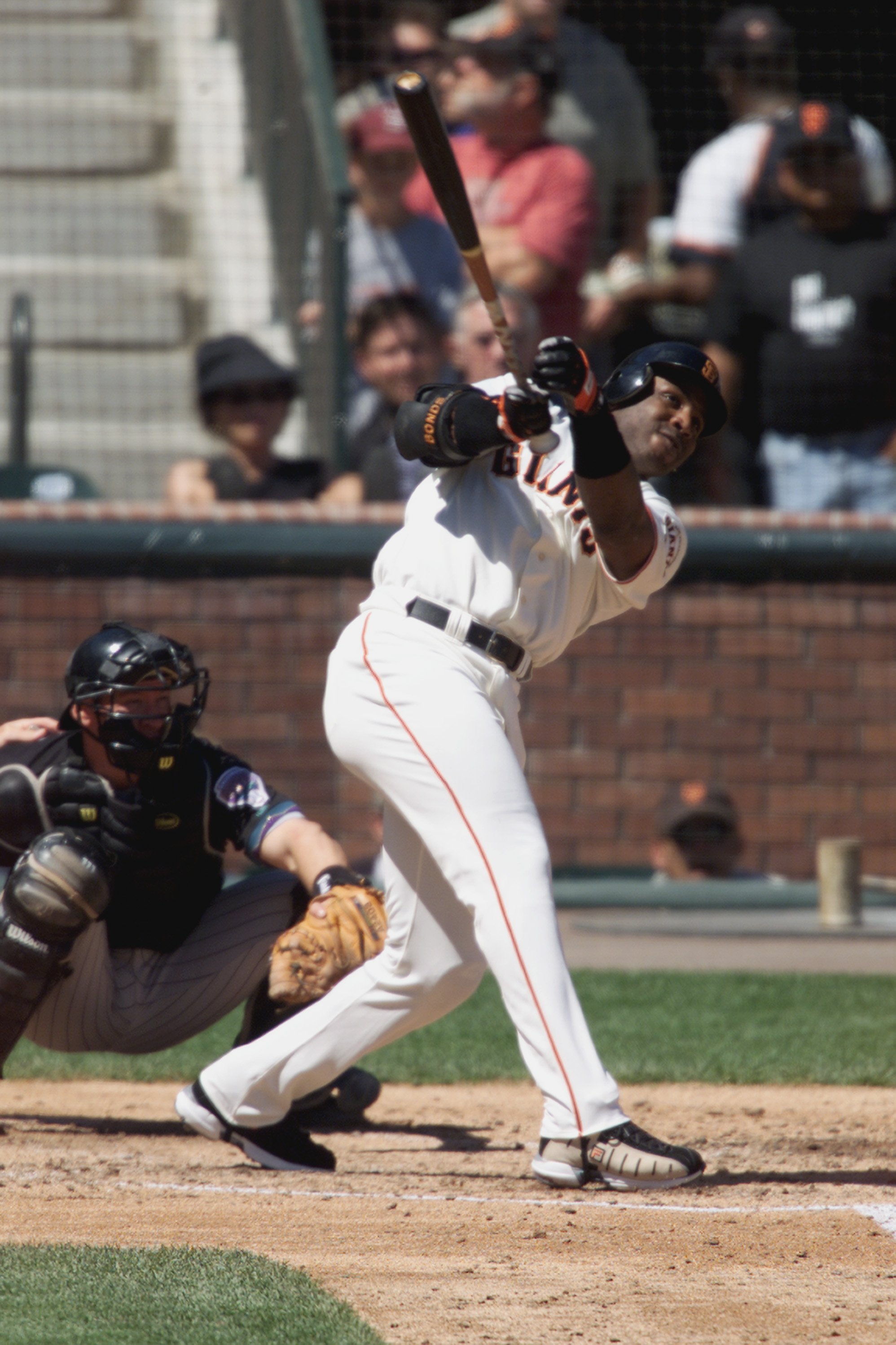 San Francisco Giant Barry Bonds removes his batting armor as he walks to  first in the first inng against the Arizona Diamondbacks. Bonds broke his  single season Major League record for walks (