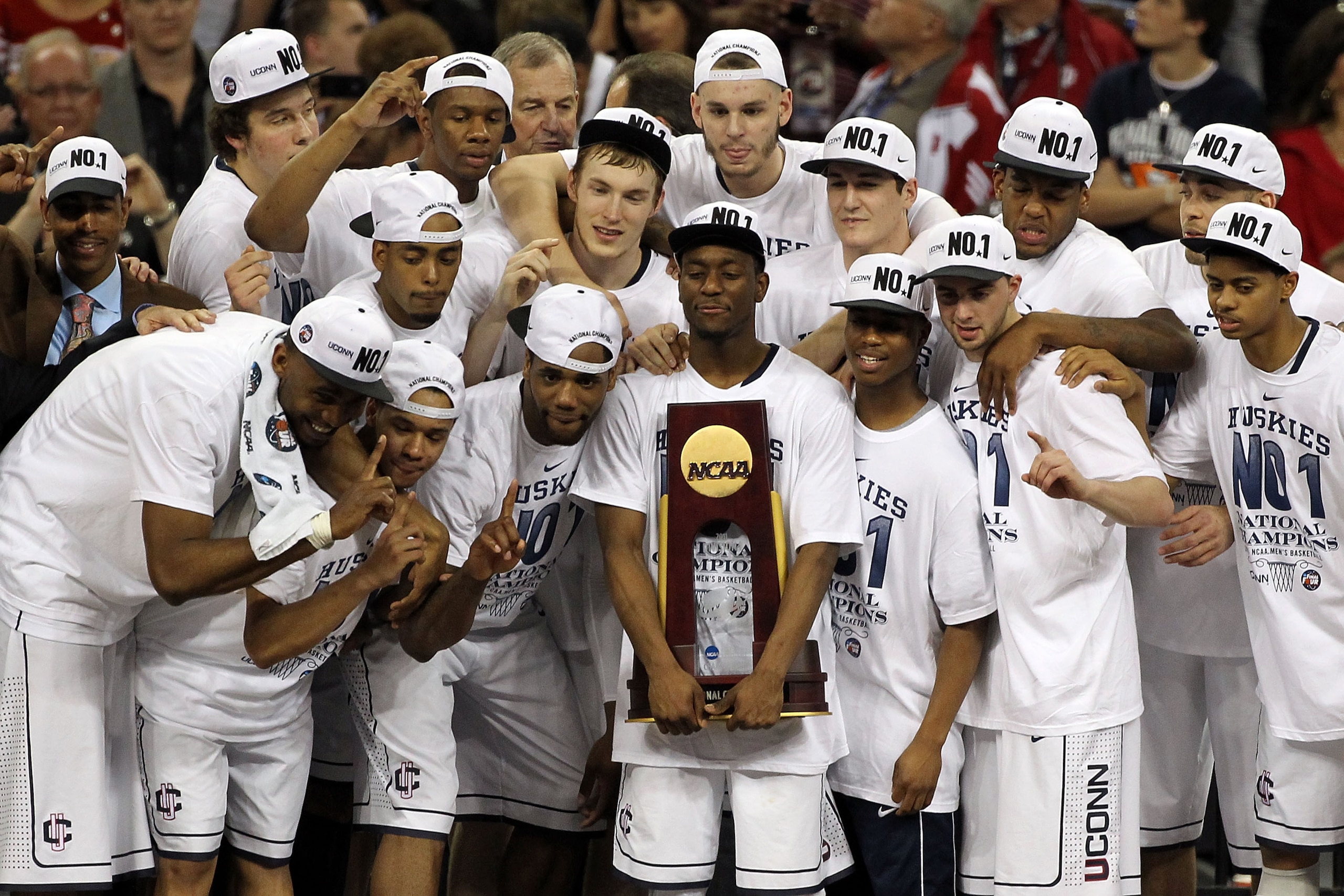 HOUSTON, TX - APRIL 04:  Kemba Walker #15 of the Connecticut Huskies holds the trophy as he and his team celebrate after defeating the Butler Bulldogs to win the National Championship Game of the 2011 NCAA Division I Men's Basketball Tournament by a score