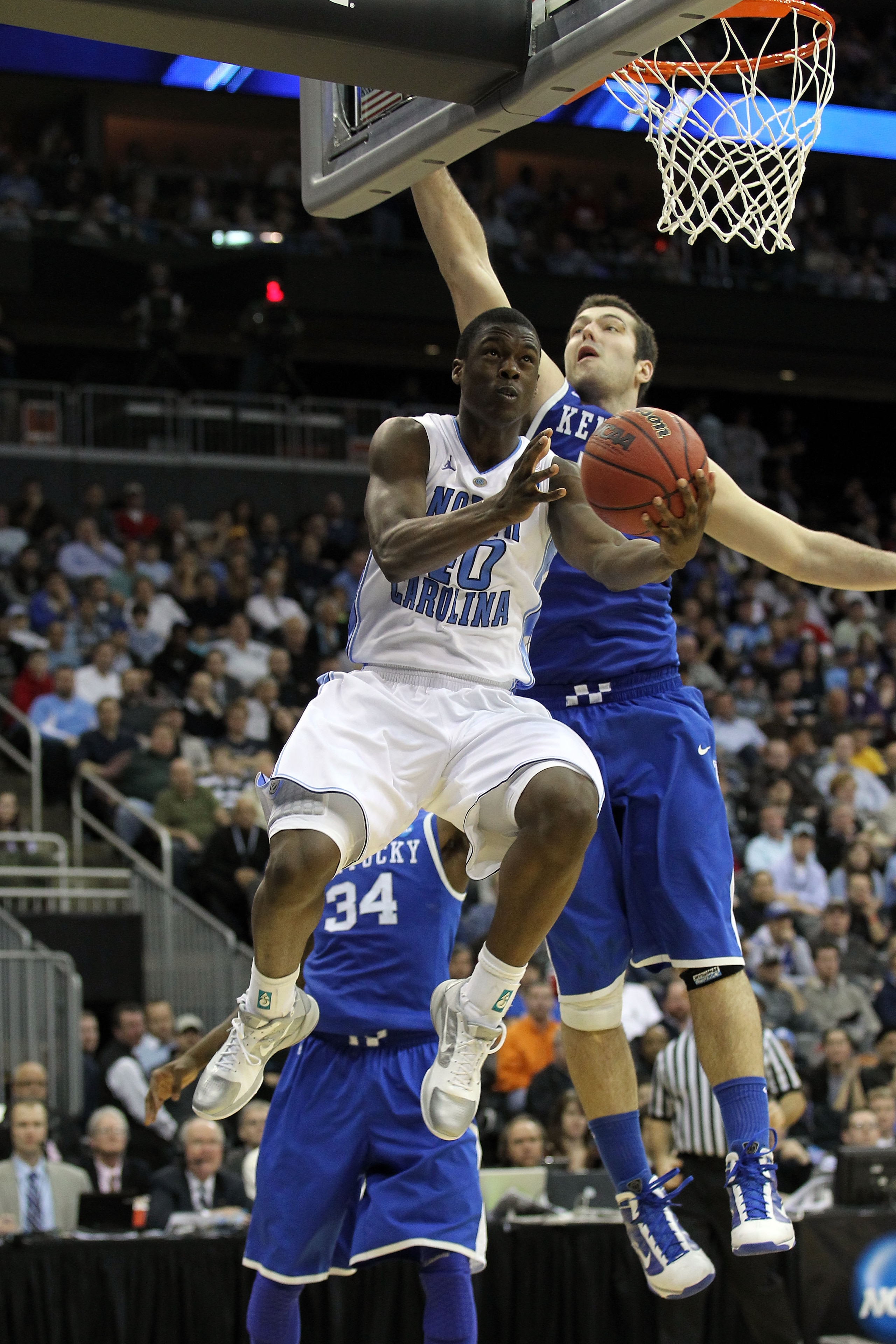 NEWARK, NJ - MARCH 27:  Harrison Barnes #40 of the North Carolina Tar Heels in action against Josh Harrellson #55 of the Kentucky Wildcats during the east regional final of the 2011 NCAA men's basketball tournament at Prudential Center on March 27, 2011 i