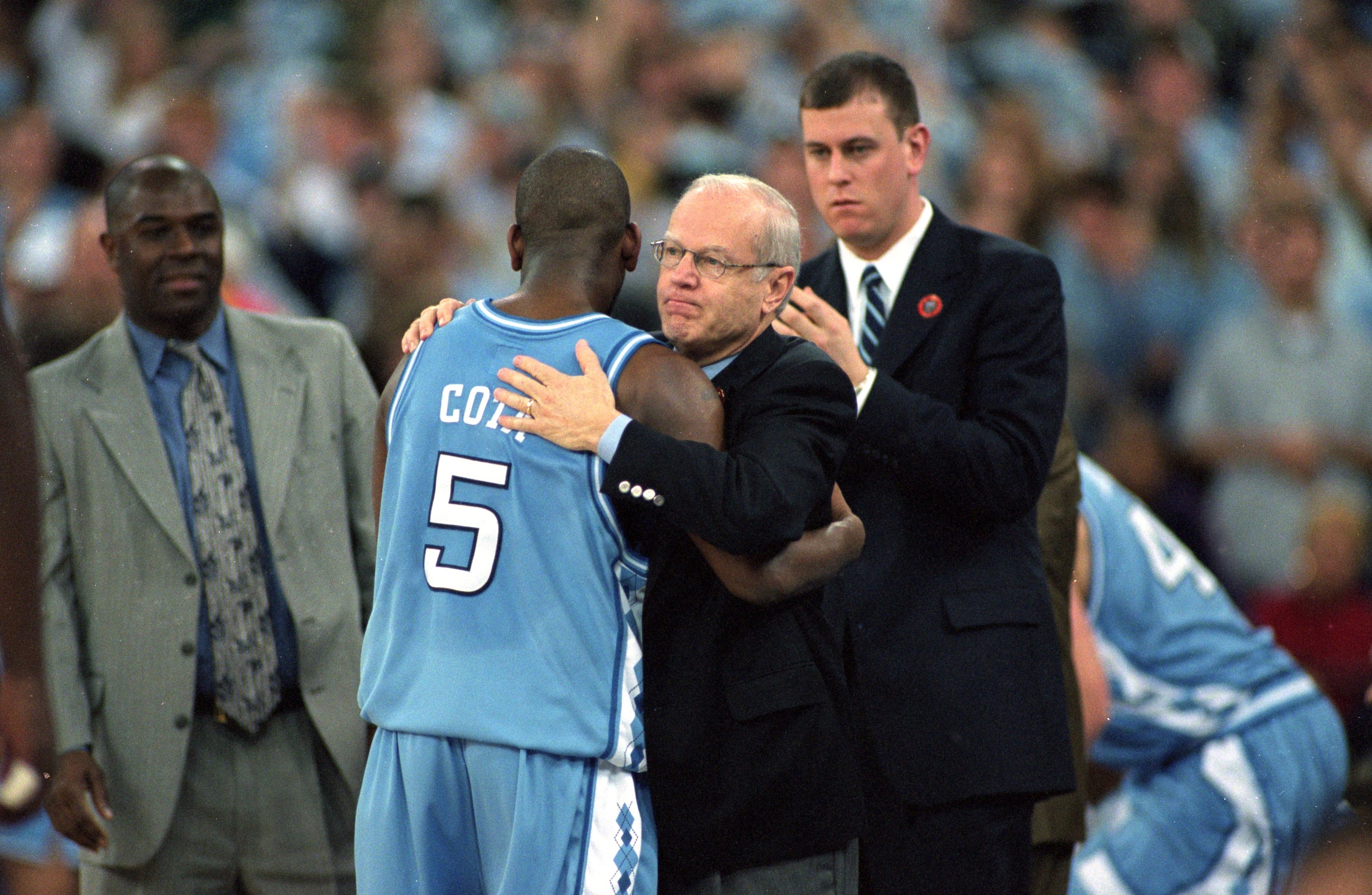 Head Coach Bill Guthridge hugs Ed Cota #5 of the North Carolina Tar Heels during the NCAA Men''s Finals Four Game against the Florida Gators at the RCA Dome in Indianapolis, Indiana. The Gators defeated the Tar Heels 71-59.