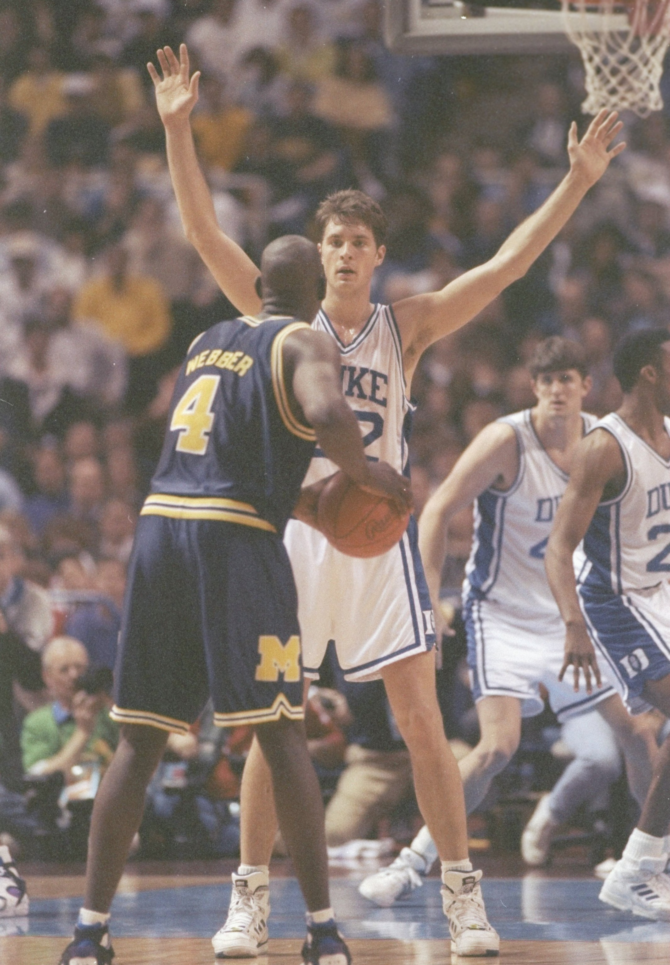 6 Apr 1992:  Forward Chris Webber of the Michigan Wolverines tries to fend off center Christian Laettner of the Duke Blue Devils during a playoff game at the Hubert H. Humphrey Metrodome in Minneapolis, Minnesota.  Duke won the game 71-51. Mandatory Credi