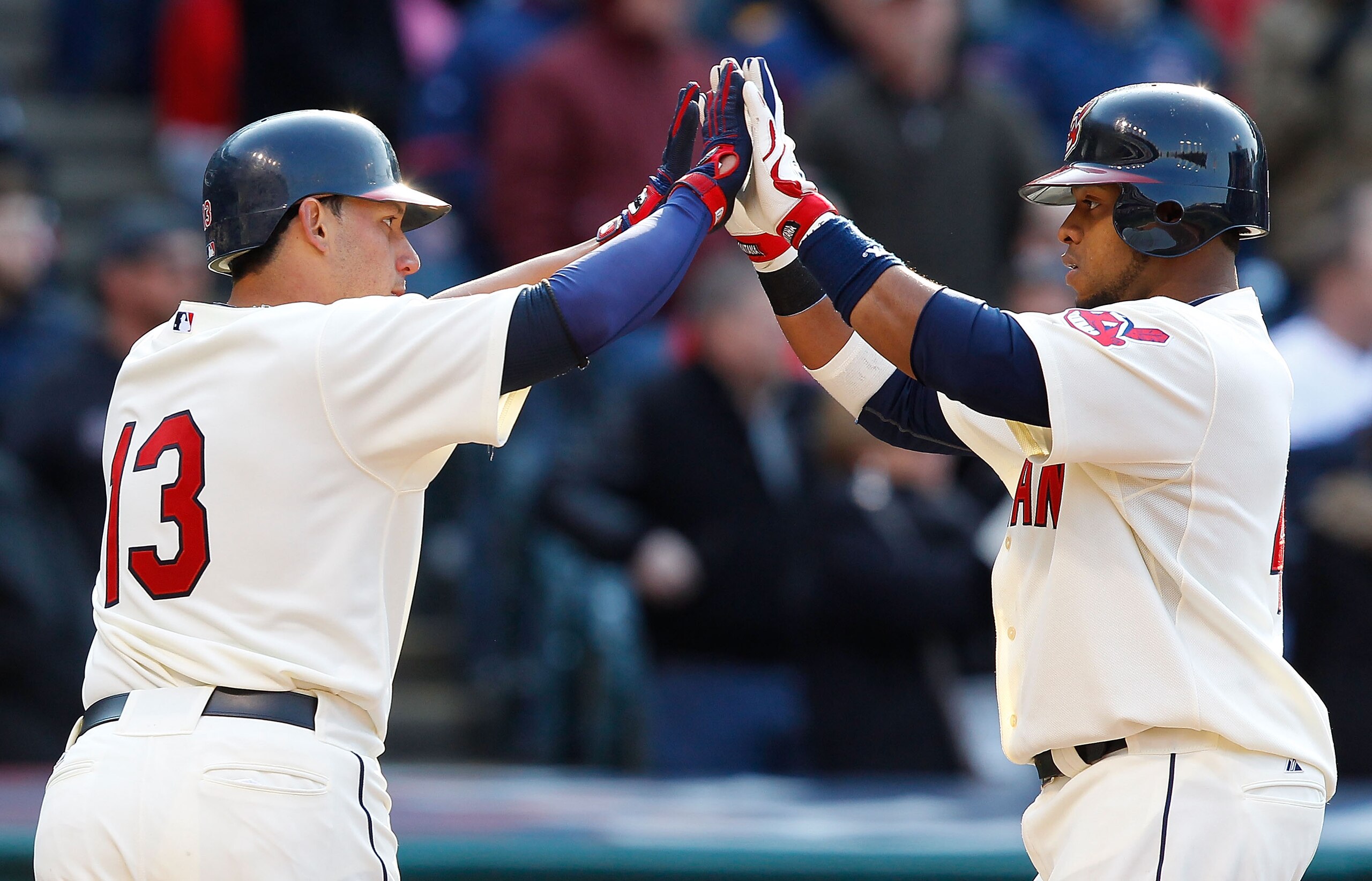 CLEVELAND - APRIL 01:  Carlos Santana #41 and Asdrubal Cabrera #13 of the Cleveland Indians celebrate after scoring against the Chicago White Sox during the Opening Day game on April 1, 2011 at Progressive Field in Cleveland, Ohio.  (Photo by Jared Wicker