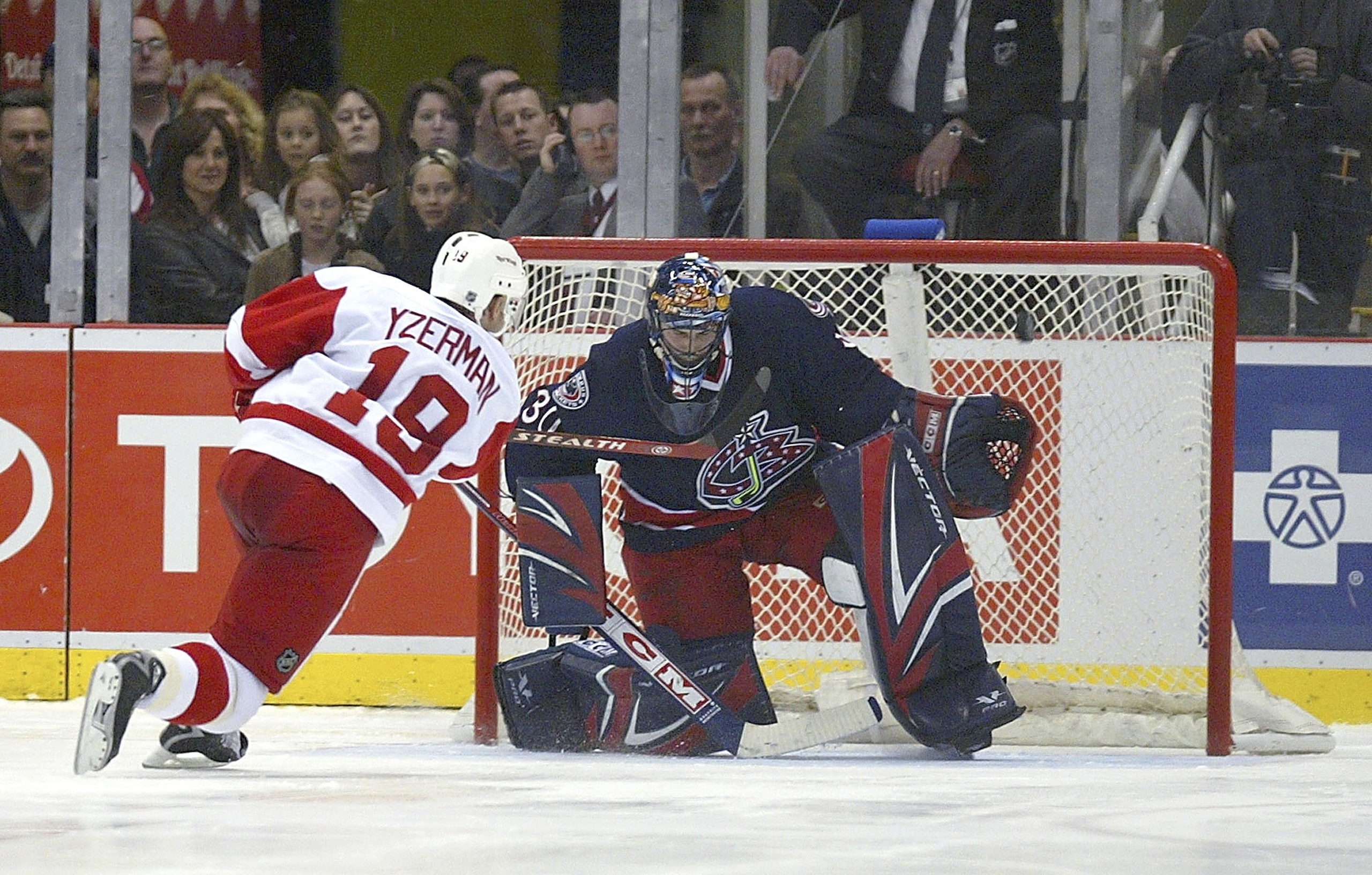 DETROIT - APRIL 7:  Steve Yzerman #19 of the Detroit Red Wings rings a shot off the crossbar against Marc Denis #30 of the Columbus Blue Jackets during their shootout at Joe Louis Arena on April 7, 2006 in Detroit, Michigan. The Red Wings defeated the Blu