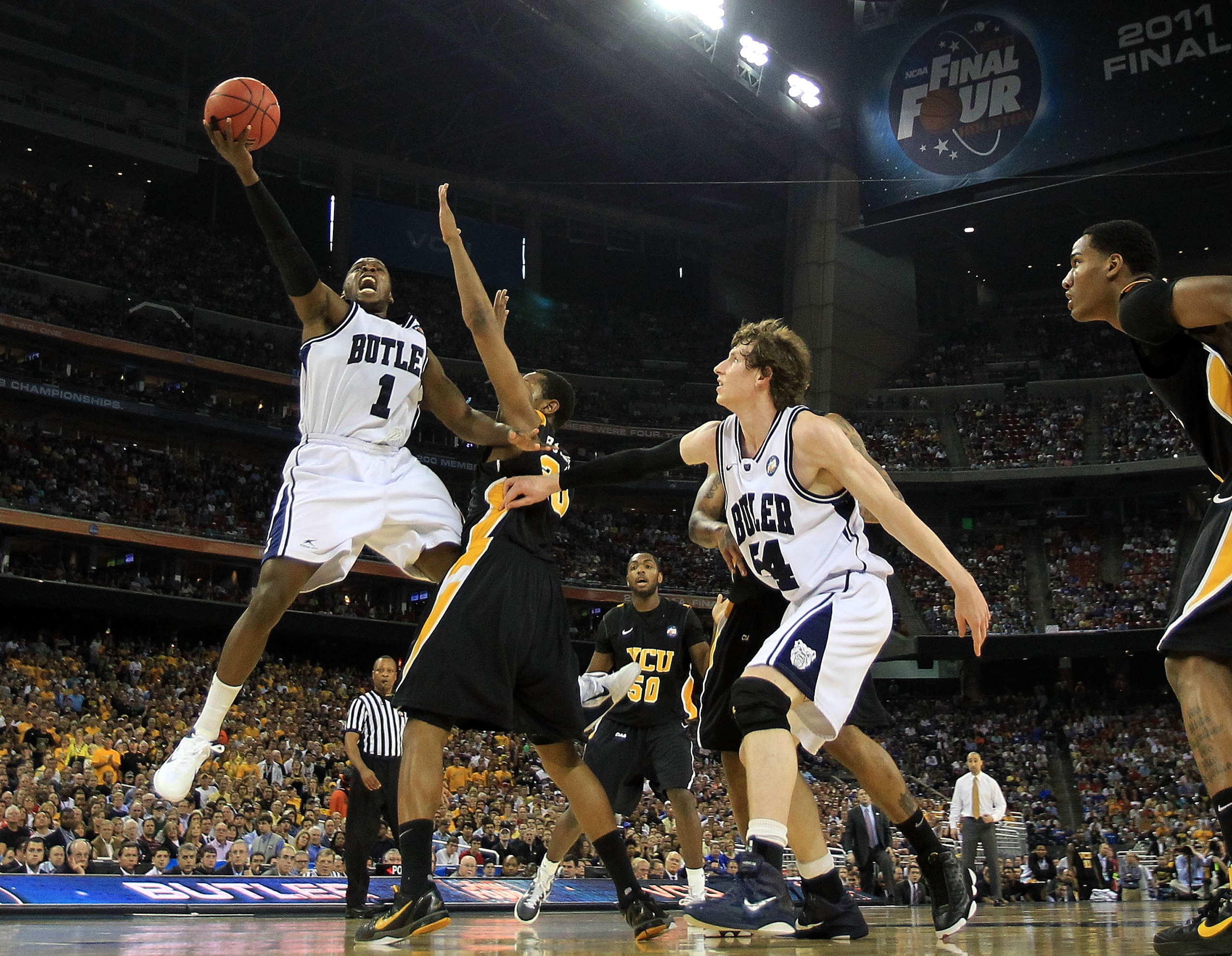 HOUSTON, TX - APRIL 02:  Shelvin Mack #1 of the Butler Bulldogs goes to the hoop against Bradford Burgess #20 of the Virginia Commonwealth Rams during the National Semifinal game of the 2011 NCAA Division I Men's Basketball Championship at Reliant Stadium