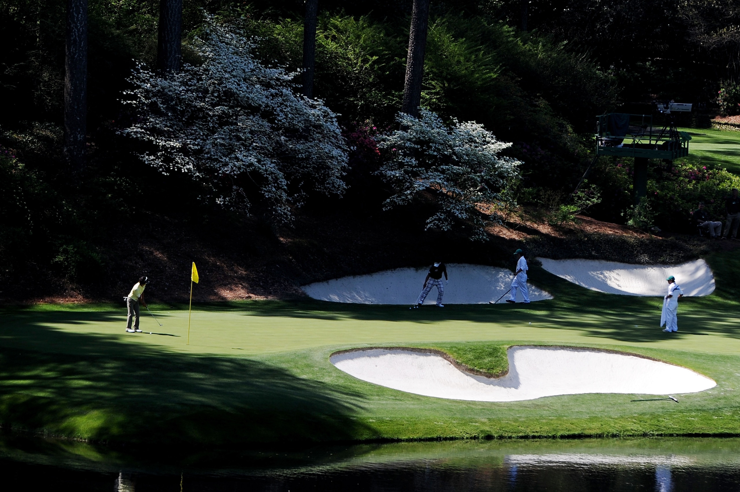 AUGUSTA, GA - APRIL 04:  Hiroyuki Fujita (R) and Ryo Ishikawa of Japan wait with their caddies on the 12th green during a practice round prior to the 2011 Masters Tournament at Augusta National Golf Club on April 4, 2011 in Augusta, Georgia.  (Photo by Ha