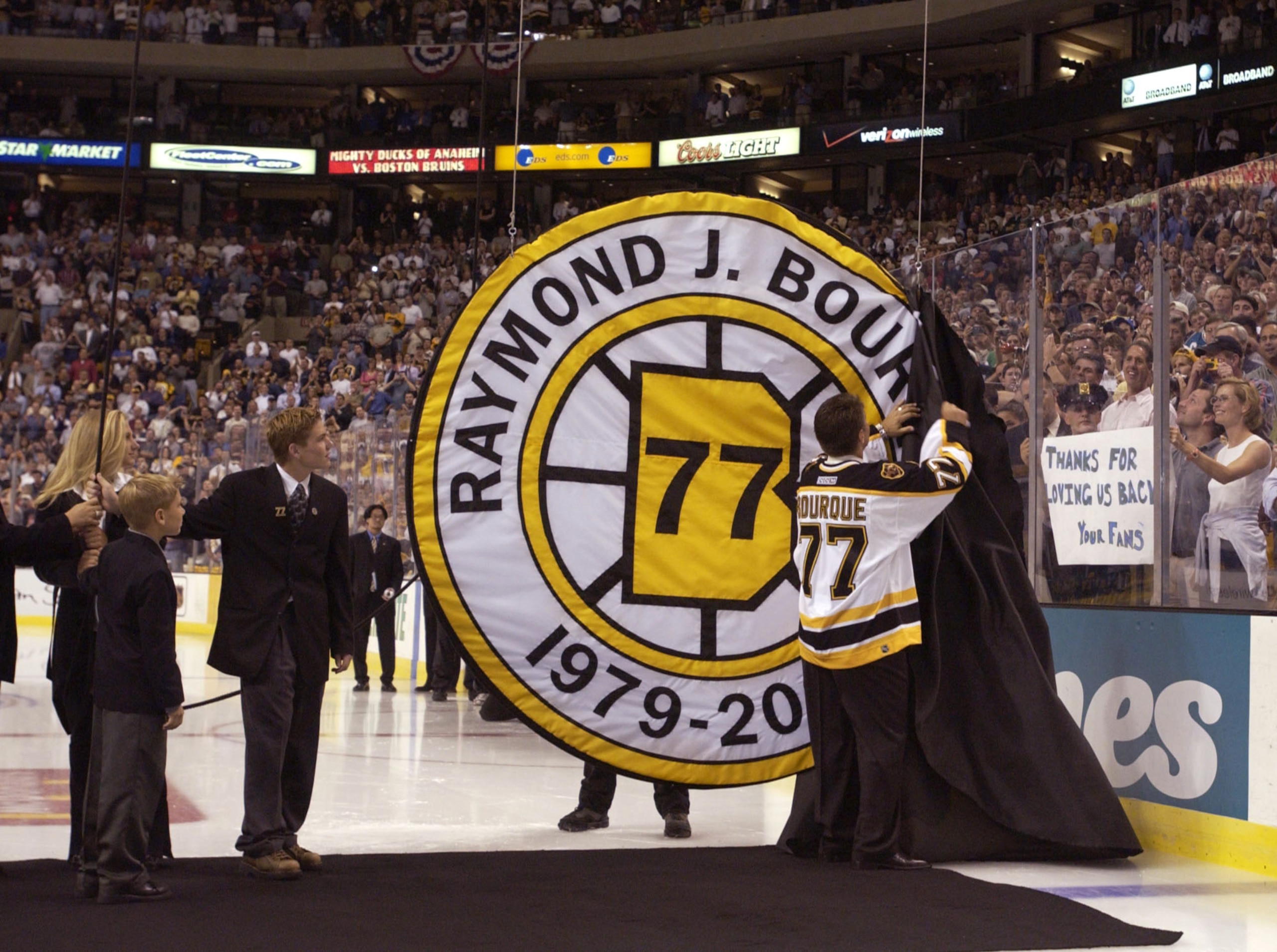 4 Oct 2001:  Ray Bourque #77 of the Boston Bruins uncovers his number during a ceremony in which the Bruins retired his number before their home opener against the Anaheim Mighty Ducks at the Fleet Center in Boston, Massachusetts. <DIGITAL IMAGE>    Manda