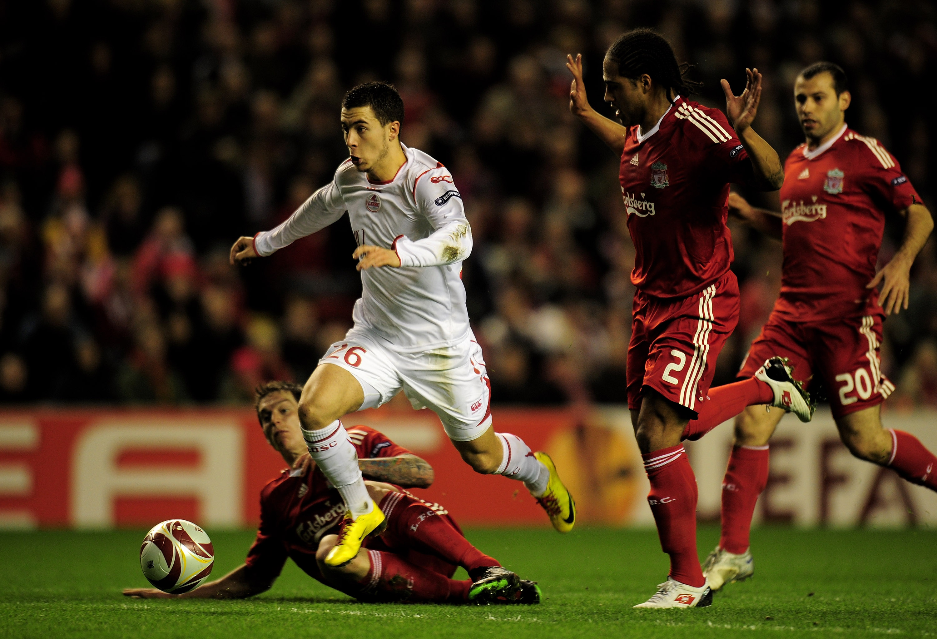 LIVERPOOL, ENGLAND - MARCH 18:  Eden Hazard of Lille breaks clear of the challenges of Daniel Agger and Glen Johnson (R) of Liverpool during the UEFA Europa League Round of 16, second leg match at Anfield on March 18, 2010 in Liverpool, England.  (Photo b