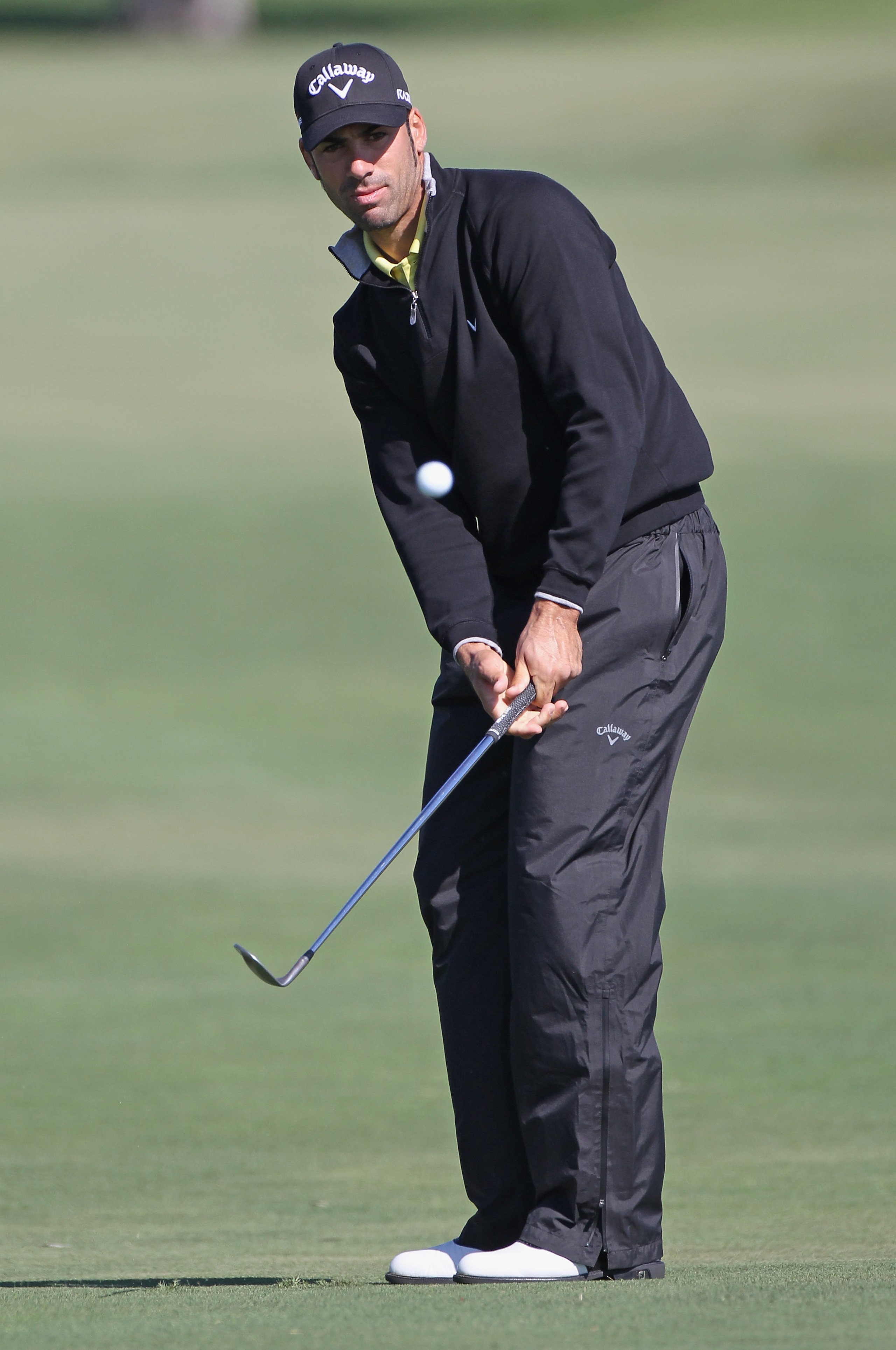 DORAL, FL - MARCH 11:  Alvaro Quiros of Spain hits a pitch shot on the eighth hole during the completion of the first round of the 2011 WGC- Cadillac Championship at the TPC Blue Monster at the Doral Golf Resort and Spa on March 11, 2011 in Doral, Florida