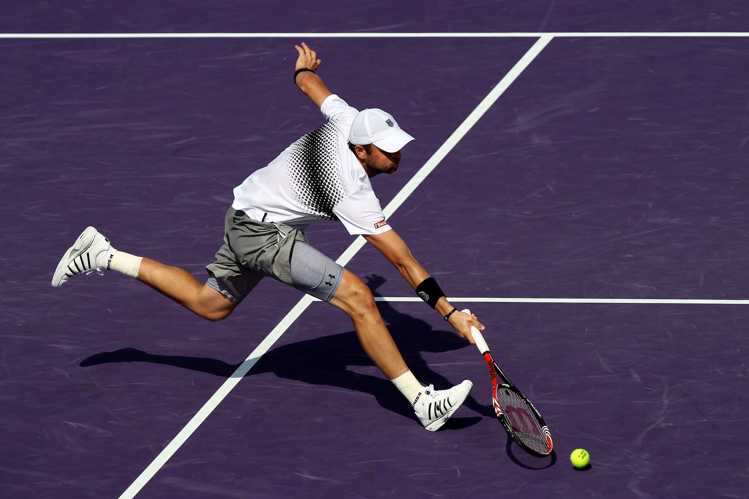 KEY BISCAYNE, FL - MARCH 30:  Mardy Fish stretches for a return against David Ferrer of Spain during the Sony Ericsson Open at Crandon Park Tennis Center on March 30, 2011 in Key Biscayne, Florida.  (Photo by Clive Brunskill/Getty Images)