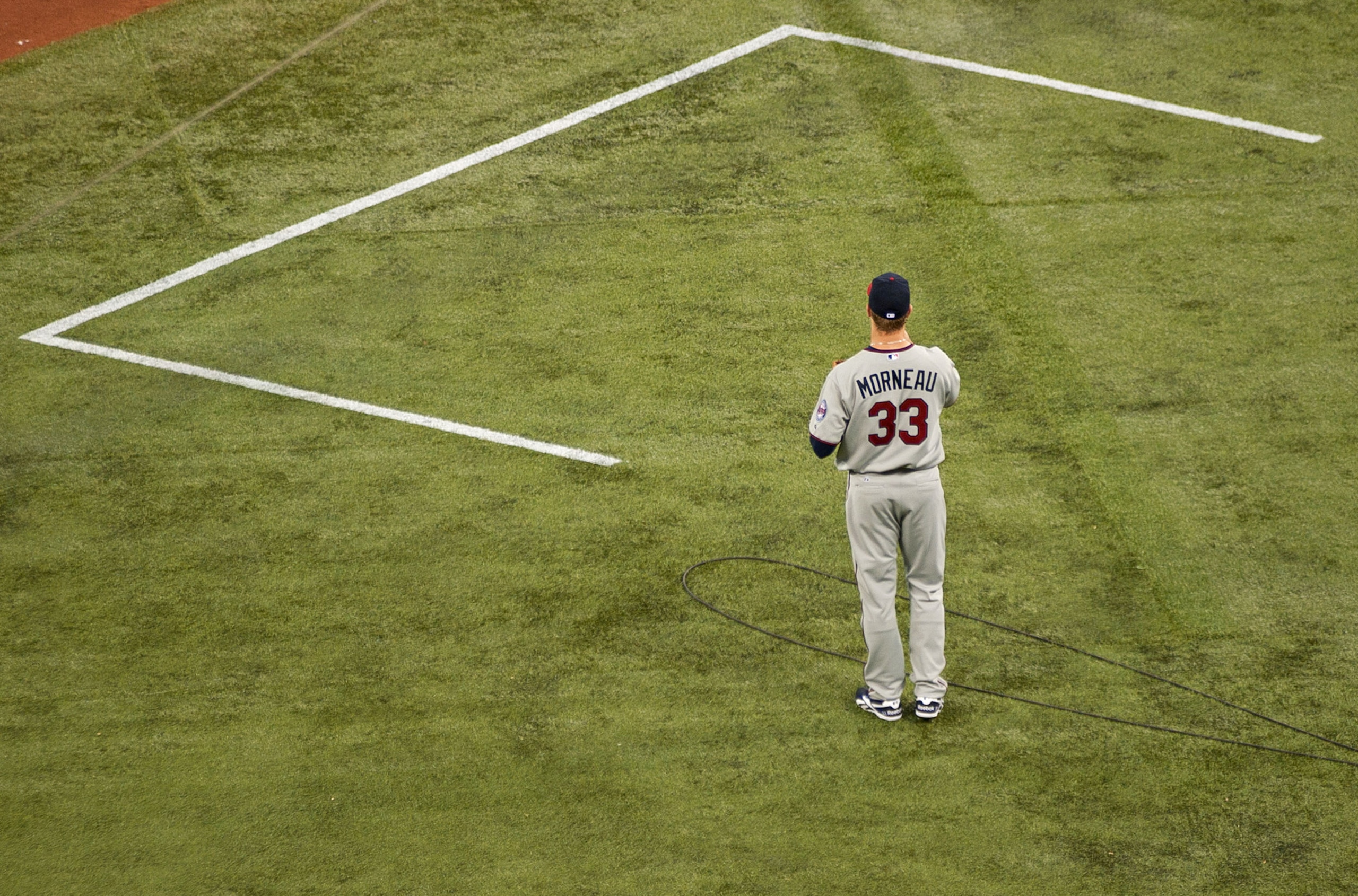 TORONTO,CANADA - APRIL 1:  Justin Morneau #33 of the Minnesota Twins gets ready to walk on the field prior to the home opener for the Toronto Blue Jays as they face the Minnesota Twins during their MLB game at the Rogers Centre April 1, 2011 in Toronto, O
