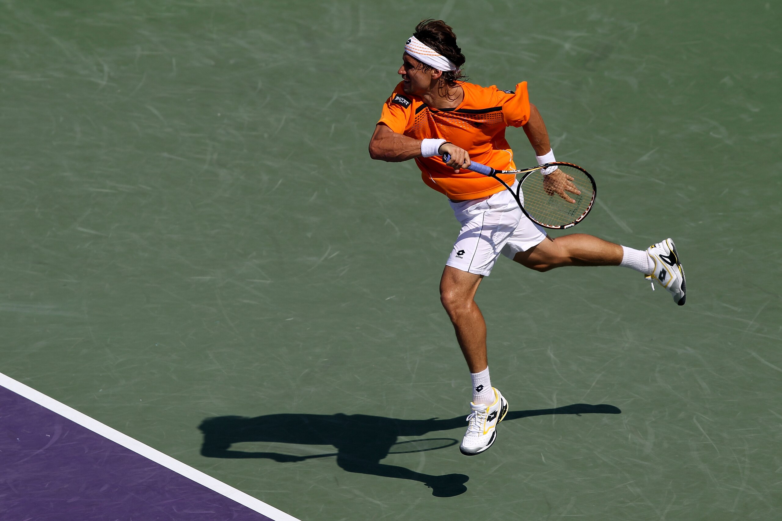 KEY BISCAYNE, FL - MARCH 30:  David Ferrer of Spain follows through on a return against Mardy Fish during the Sony Ericsson Open at Crandon Park Tennis Center on March 30, 2011 in Key Biscayne, Florida.  (Photo by Clive Brunskill/Getty Images)