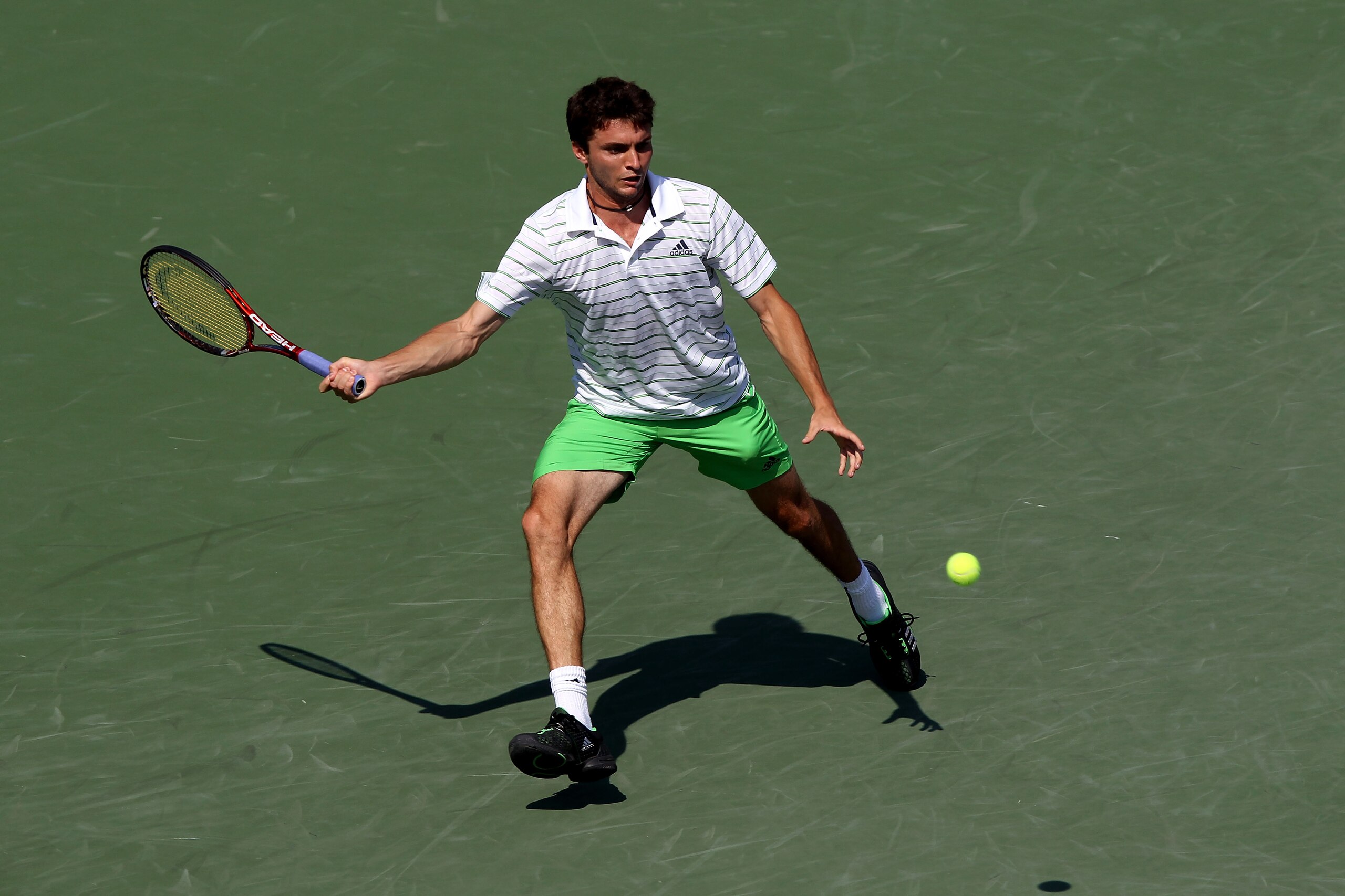 KEY BISCAYNE, FL - MARCH 31:  Gilles Simon of France hits a forehand return against Roger Federer of Switzerland of during the Sony Ericsson Open at Crandon Park Tennis Center on March 31, 2011 in Key Biscayne, Florida.  (Photo by Clive Brunskill/Getty Im