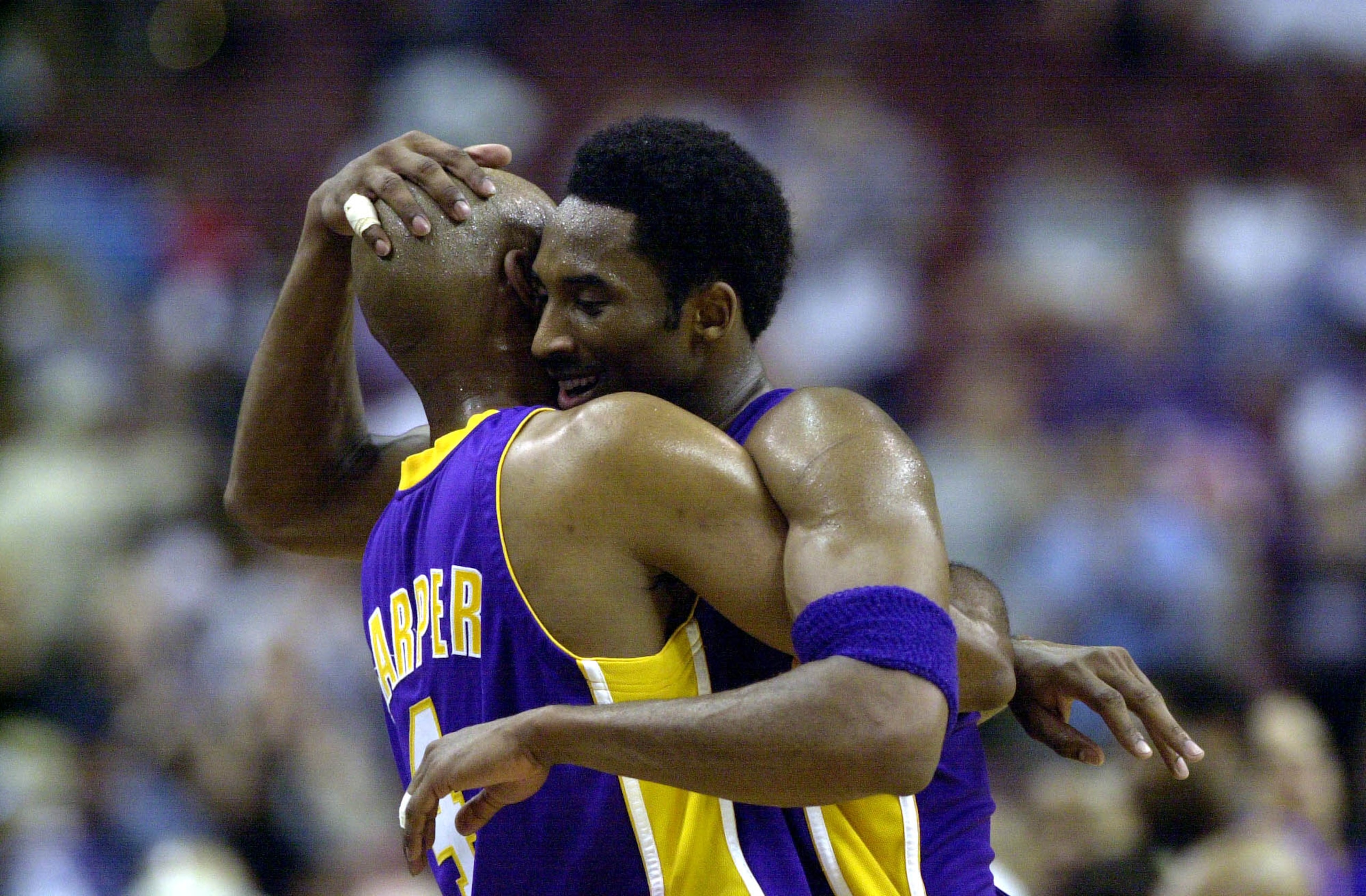 13 Jun 2001: Kobe Bryant #8 of the Los Angeles Lakers receives a hug from teammate Ron Harper #4 after defeating the Philadelphia 76ers 100-86 in game four of the NBA Finals at the First Union Center in Philadelphia, Pennsylvania. DIGITAL IMAGE. Manda 13 Jun 2001: Kobe Bryant #8 of the Los Angeles Lakers receives a hug from teammate Ron Harper #4 after defeating the Philadelphia 76ers 100-86 in game four of the NBA Finals at the First Union Center in Philadelphia, Pennsylvania. DIGITAL IMAGE. Manda