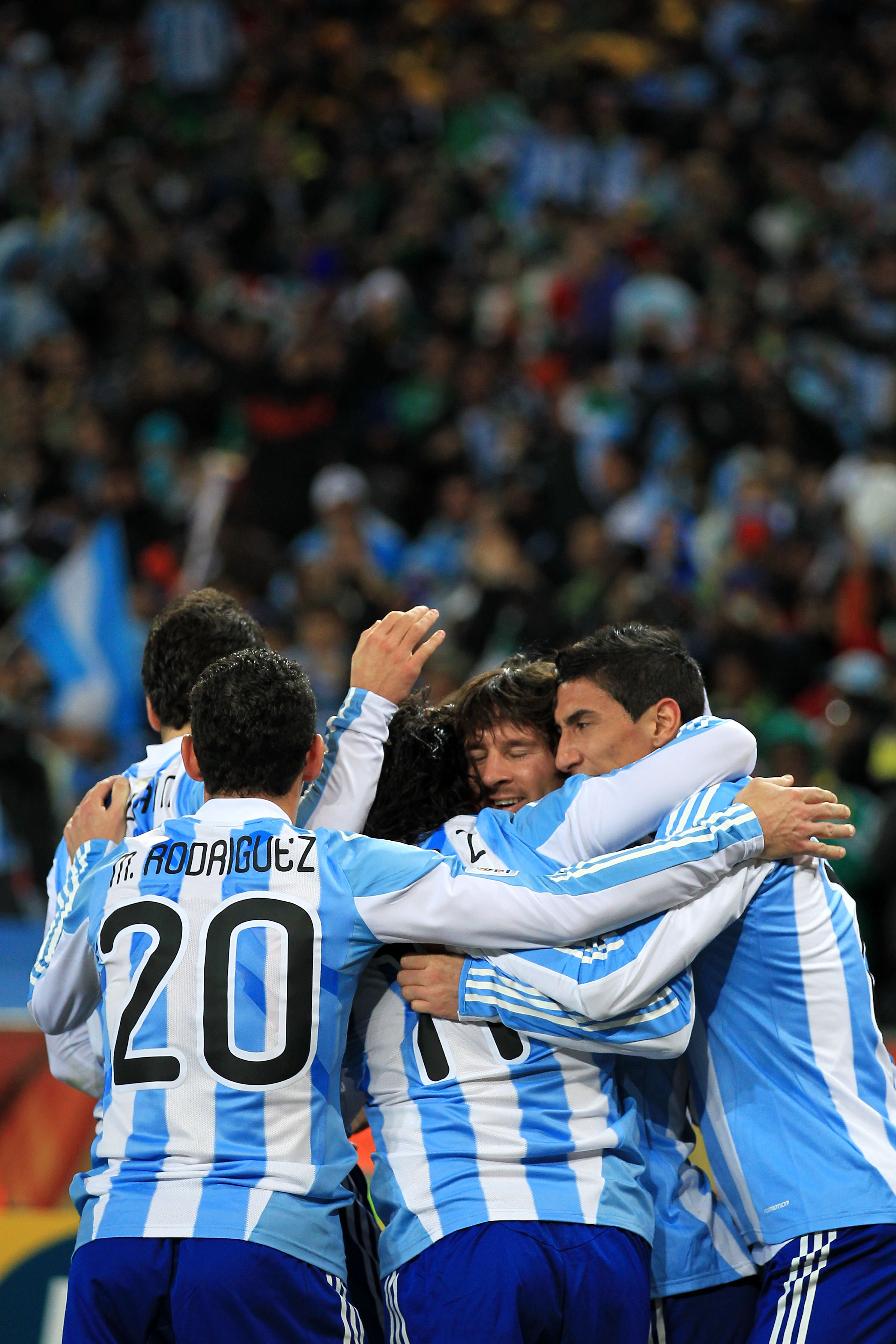 JOHANNESBURG, SOUTH AFRICA - JUNE 27:  Lionel Messi of Argentina (C) hugs goalscorer Carlos Tevez as they celebrate the opening goal during the 2010 FIFA World Cup South Africa Round of Sixteen match between Argentina and Mexico at Soccer City Stadium on