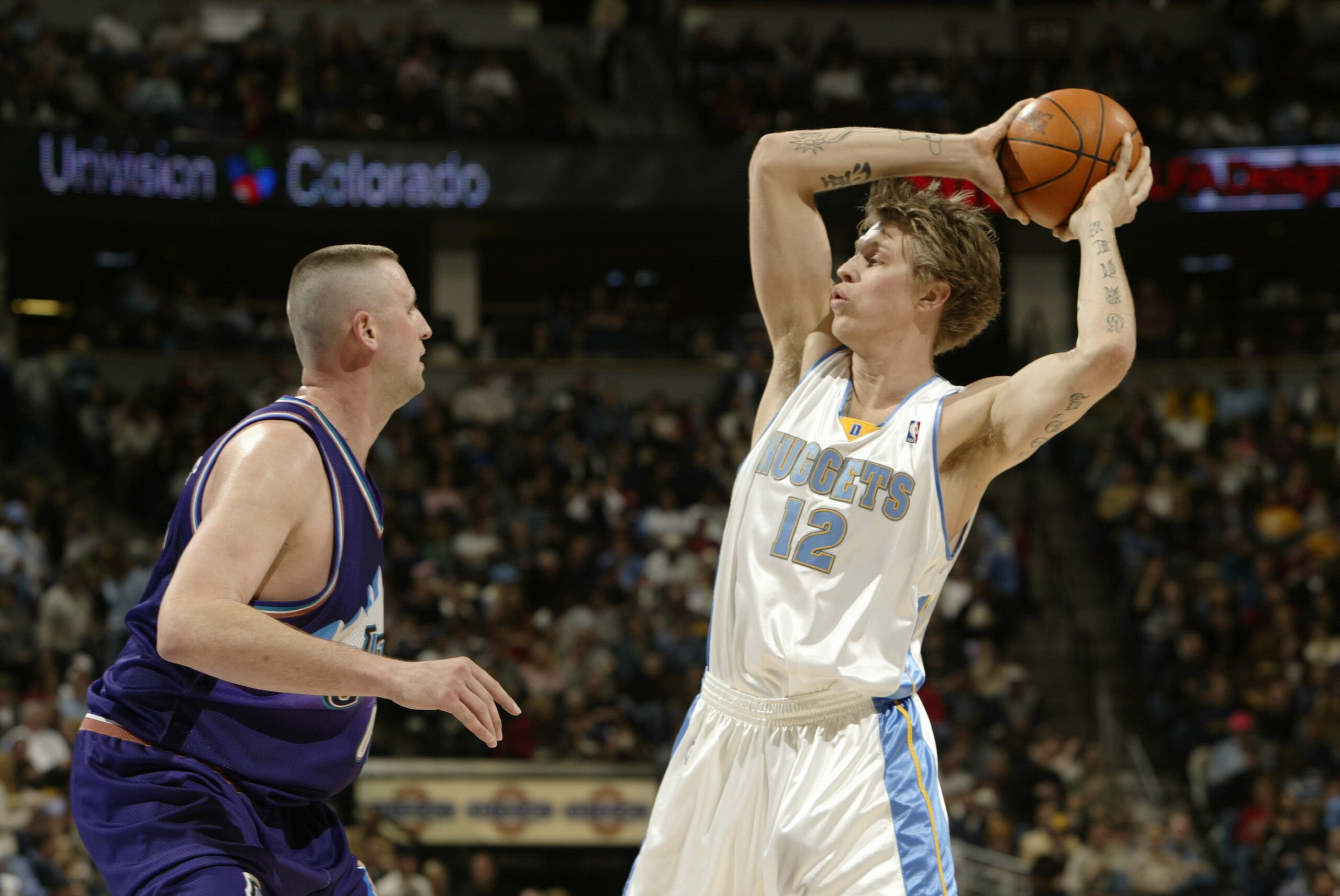 DENVER - JANUARY 9: Chris Andersen #12 of the Denver Nuggets looks to pass as he is guarded by Greg Ostertag #00 of the Utah Jazz during the game on January 9, 2004 at the Pepsi Center in Denver, Colorado. The Nuggets won 106-96. NOTE TO USER: User exp DENVER - JANUARY 9: Chris Andersen #12 of the Denver Nuggets looks to pass as he is guarded by Greg Ostertag #00 of the Utah Jazz during the game on January 9, 2004 at the Pepsi Center in Denver, Colorado. The Nuggets won 106-96. NOTE TO USER: User exp